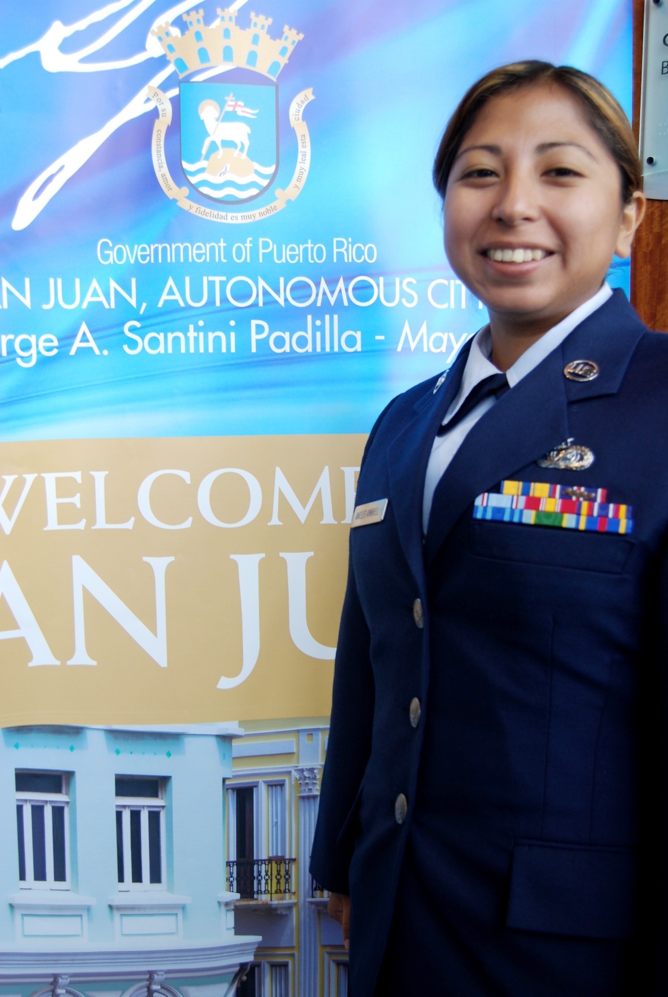 Tech. Sgt. Alyson Angeles-Kimbrell pauses for a smile at the League of United Latin American Citizens convention and exposition July 17 in San Juan, Puerto Rico. Sergeant Angeles-Kimbrell was one of dozens of Air Force reservists who spoke to local high school and college students to educate them about opportunities in the Air Force. Sergeant  Angeles-Kimbrell is an information manager on full-time orders with the 349th Air Mobility Wing from Travis Air Reserve Base, Calif. (U.S. Air Force photo/Tech. Sgt. Amaani Lyle)
