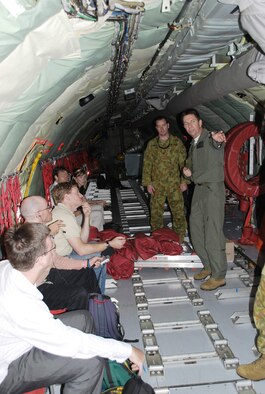 Royal Australian Air Force Warrant Officer Darrell Bent briefs emergency egress procedures to passengers aboard a KC-135 Stratotanker July 19 over Australia. The KC-135 is from the 909th Air Refueling Squadron from Kadena Air Base, Japan, and is in Australia participating in Exercise Talisman Saber 2009. Warrant Officer Bent is an air refueling operator. (U.S. Air Force photo/Capt. Bryan Lewis) 