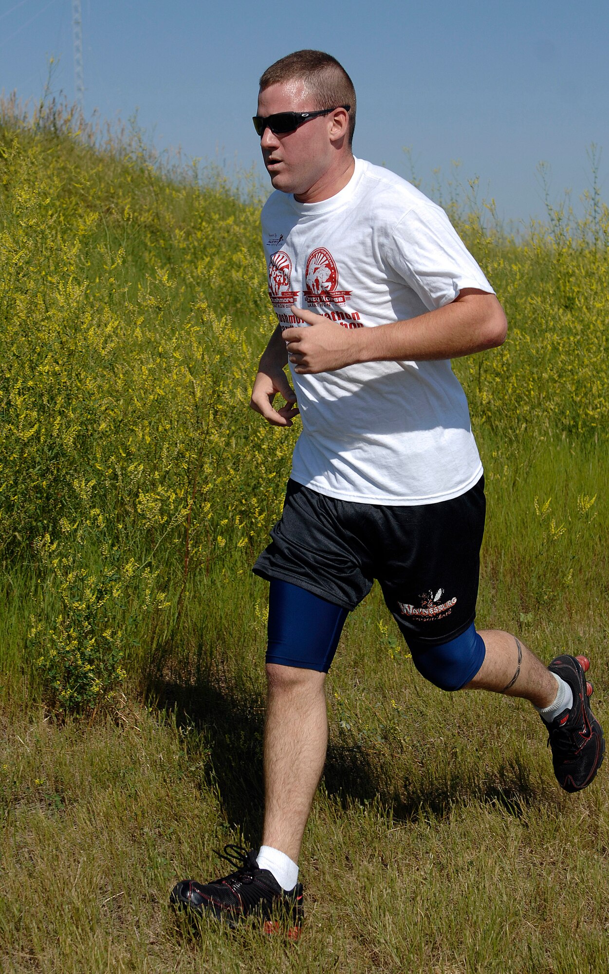 Airman 1st Class Stephen Scally, Security Forces Squadron patrolman, approaches a checkpoint during the Raider Challenge Biathlon here, July 17. The Biathlon consisted of a three-mile run and a nine-mile bicycle ride. (U.S. Air Force photo/Airman 1st Class Joshua J. Seybert)
