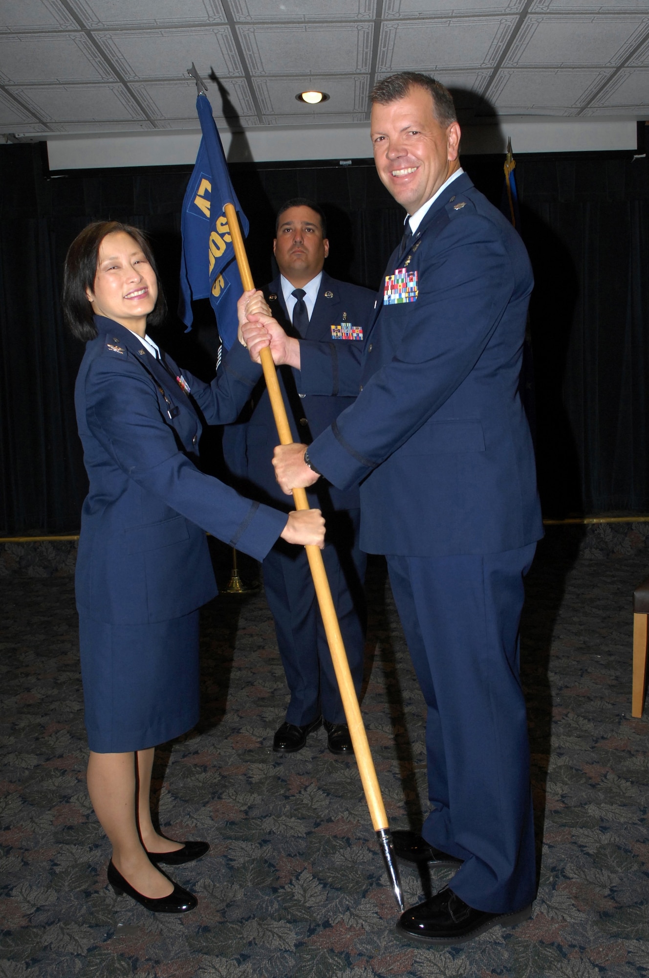 LAUGHLIN AIR FORCE BASE, Texas -- Col. Lawra Lee, 47th Medical Group commander, passes the 47th Medical Operations Squadron guidon to Lt. Col. Timothy Cook, 47th Medical Operations Squadron commander, during the 47th MDOS change-of-command ceremony July 1 at 1 p.m.  (U.S. Air Force photo by Jose Mendoza)