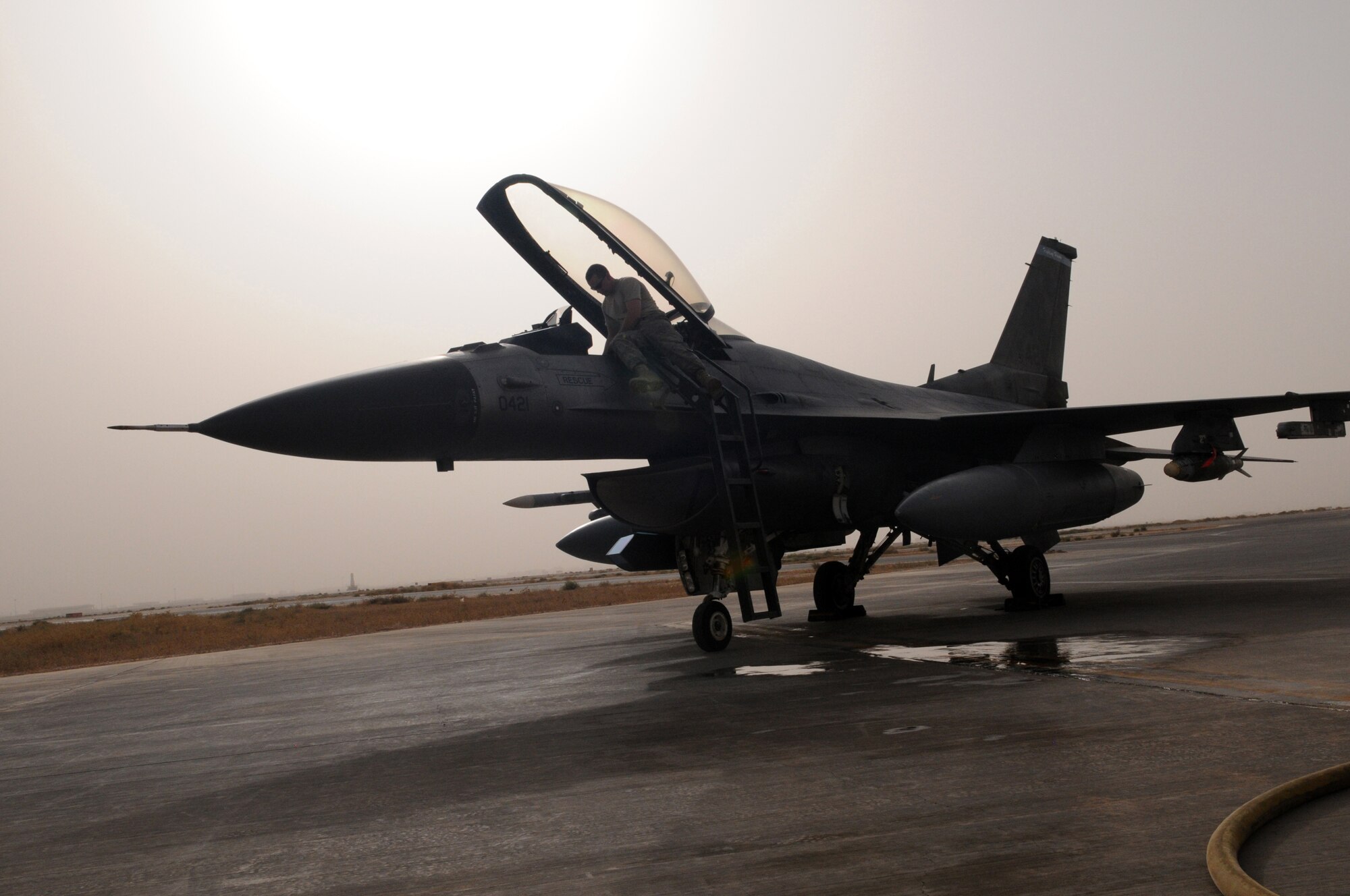 JOINT BASE BALAD, Iraq -- An F-16 Fighting Falcon from the 22nd Fighter Squadron at Spangdahlem Air Base, Germany, receives service after returning from a combat sortie flown July 17.  The jets are assigned to Joint Base Balad in support of Operation Iraqi Freedom. (U.S. Air Force photo by Staff Sgt. Heather Norris)
