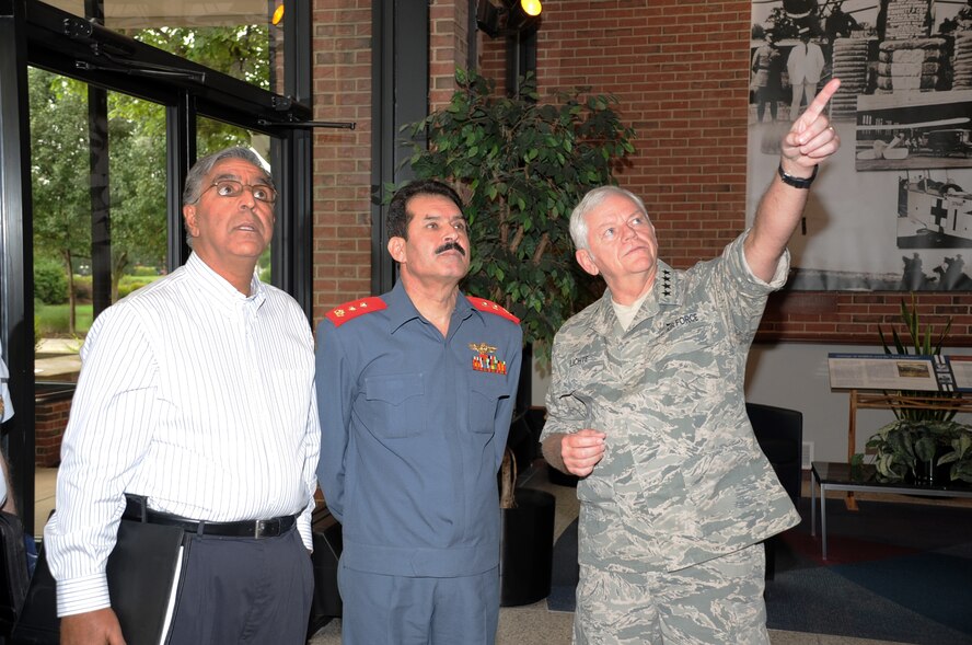 SCOTT AIR FORCE BASE, Ill. ? Upon entering the Air Mobility Command headquarters building here, Gen. Arthur J. Lichte, AMC commander, points out a piece of Air Mobility history to Maj. Gen. Mohammad Dawran, commander of the Afghan National Army Air Corps, and M. Monir Rafiq, Department of Defense interpreter, during the Afghan delegation's visit here July 15, 2009.  Following a short tour of AMC Heritage Hall, General Dawran received an AMC command briefing, followed by briefings and tours of the 618th Tanker Airlift Control Center; U.S. Transportation Command; the Deployment and Distribution Operations Center; and the 932nd Airlift Wing (Air Force Reserves).  General Dawran?s visit here concluded with the Scott AFB Aeromedical Staging Facility, which included a tour of an aeromedically-configured C-130 Hercules. According to AMC officials, the purpose of General Dawran's visit here was to continue an open dialog between senior military leaders of the two countries and to reinforce airlift concepts that are being applied throughout Afghanistan. (Air Force photo by Mark Diamond/AMC Public Affairs)