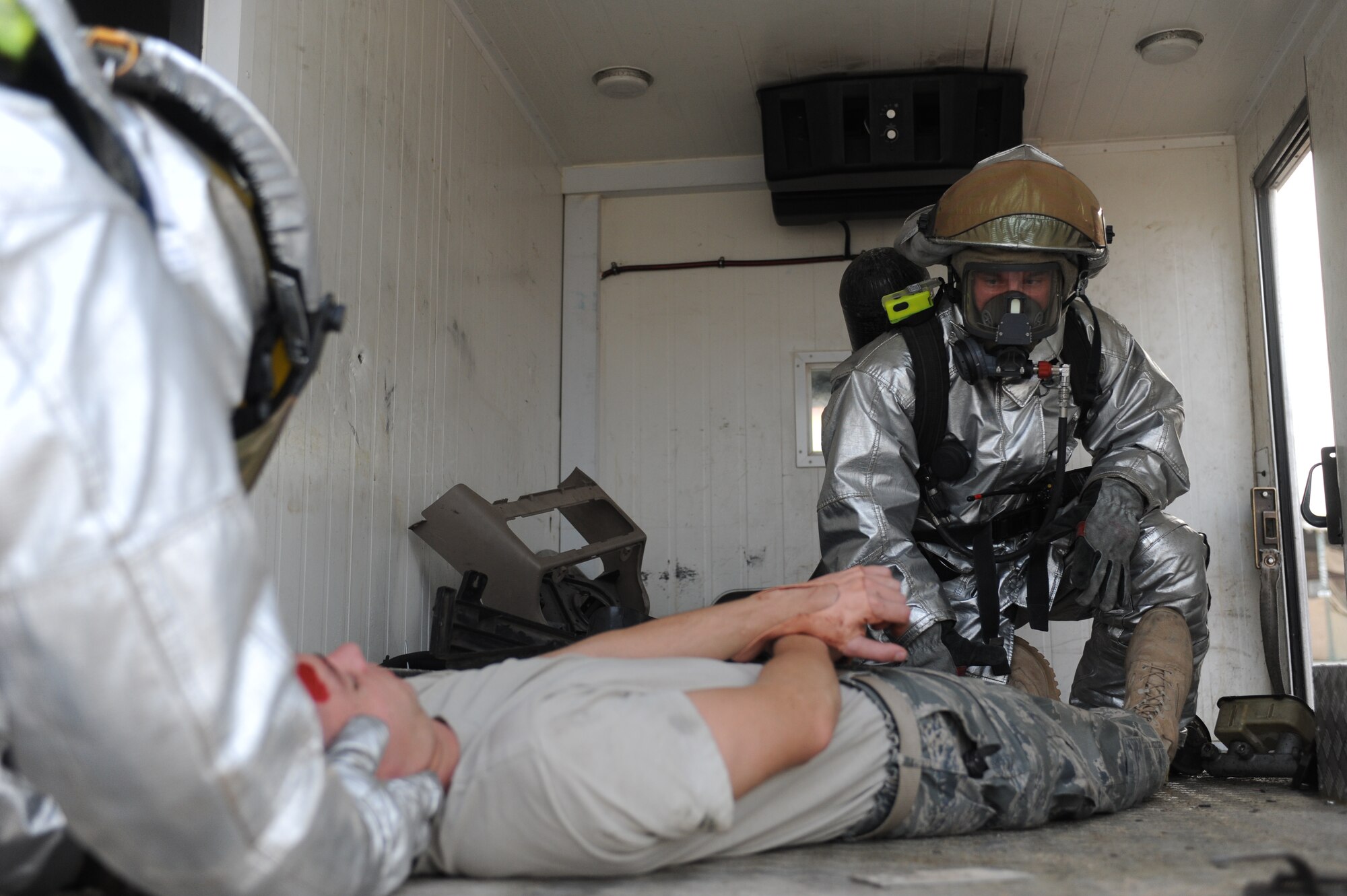 SOUTHWEST ASIA - Staff Sgt. Kevin Gantt and Senior Airman Christopher Vullmahn, 380th Expeditionary Civil Engineer Squadron, treats a simulated victim of a vehicle accident exercise July 18. Sergeant Gantt is a fire fighter currently deployed from Moody Air Force base, Ga., and hails from Tucson, Ariz. (U.S. Air Force photo Tech. Sgt. Charles Larkin Sr)