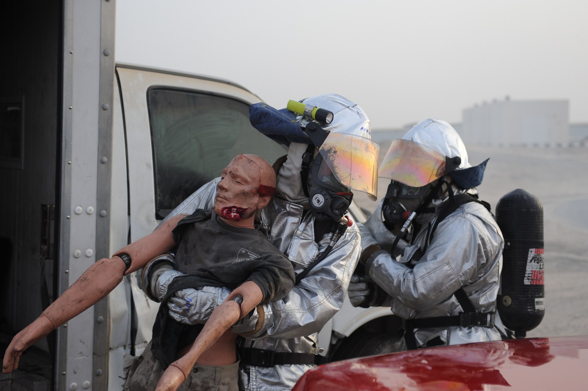 SOUTHWEST ASIA - Airman 1st Class Anthony Ankeny, 380th Expeditionary Civil Engineer Squadron, pulls a simulated victim from a vehicle accident with assistance from Staff Sgt. Kevin Gantt, 380th Expeditionary Civil Engineer Squadron July 18. Airman Ankeny is a fire fighter currently deployed from Moody Air Force base, Ga., and hails from Lawrenceville, Ga. (U.S. Air Force photo Tech. Sgt. Charles Larkin Sr)