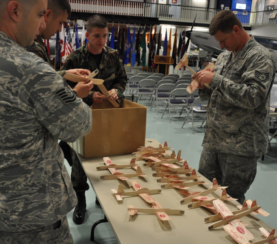 Volunteers from the 33rd Maintenance Group fix broke “jets” at the Air Armament Museum in preparation for Shalimar Elementary School’s annual “Engineers for America” program Feb. 18. The jets were used for an activity that explained the flight of the Doolittle Raiders designed to teach fifth-grade students basic aerodynamics. (Air Force photo by Chrissy Cuttita)  