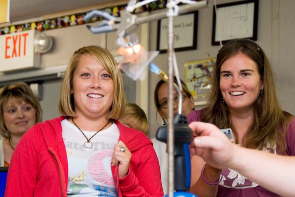 Berkeley County teachers Nicole Krause and Cathy Stickel watch their "thermal protection shield" stand up to the heat of a gas flame during a workshop hosted by the Martinsburg STARBASE at the 167th Airlift Wing, Martinsburg, WV, on July 17, 2009.  Twenty-six local teachers participated in the teacher’s academy which focused on creative ways to teach science, technology, engineering, and math to intermediate school students. On the last day of the workshop, Todd Ensign, Educator Resource Center Program Manager for NASA IV & V Facility based in Fairmont, had the teachers design a heat shield made of wire mesh and aluminum foil, similar to the thermal protection that will be used for the future Ares spacecraft which is expected to take man back to the moon.  (U.S. Air Force photo by Master Sgt Emily Beightol-Deyerle)