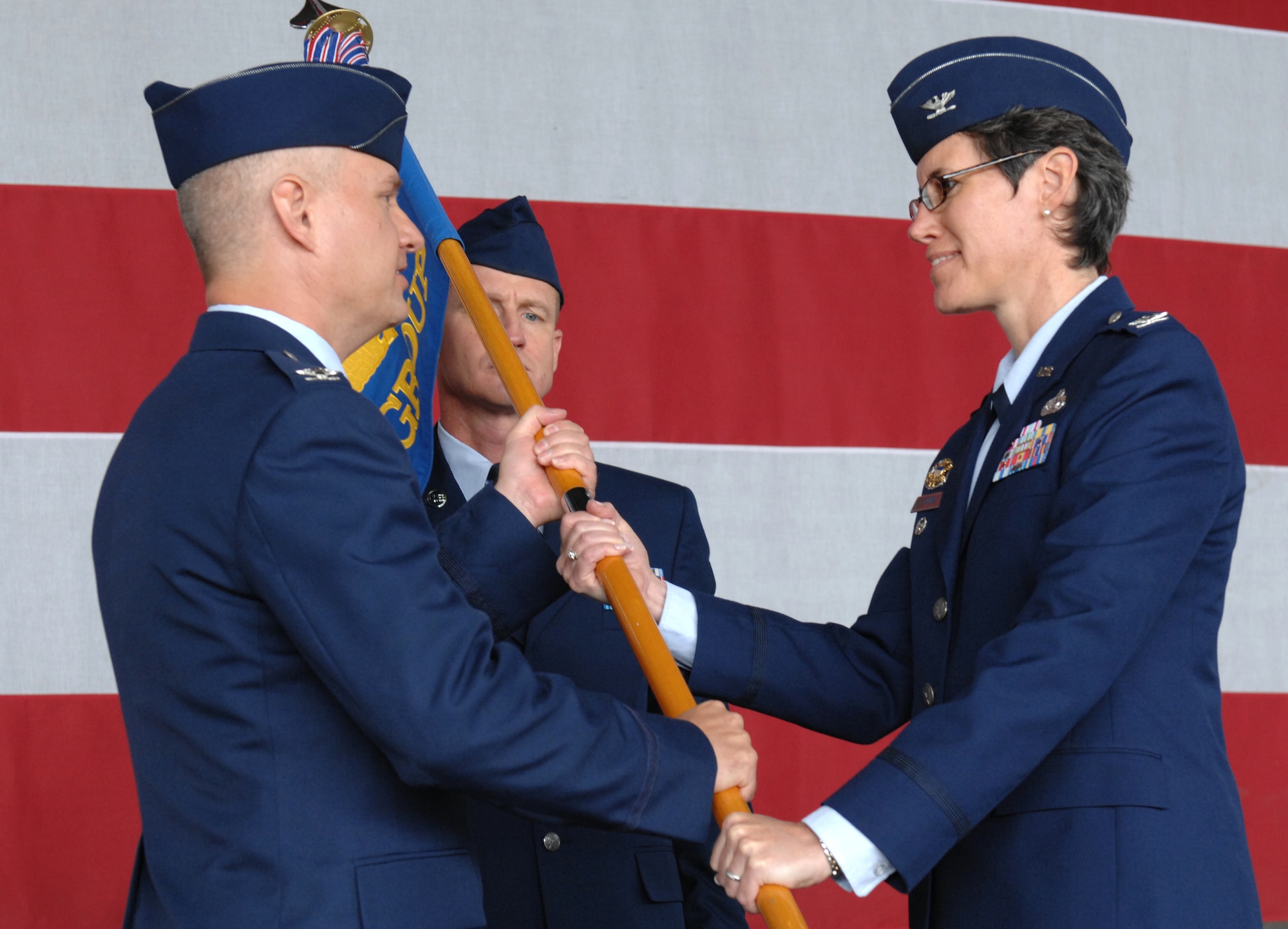 SPANGDAHLEM AIR BASE, Germany -- Col. Jodine Tooke receives the 52nd Mission Support Group guide-on from 52nd Fighter Wing Vice Commander Col. Kevin Anderson as she assumes command of the group.  Colonel Tooke, formerly the Air Force Communications Agency vice commander at Scott Air Force Base, Ill., replaced outgoing Mission Support Group Commander Col. William Nadolski at the change-of-command ceremony on July 17 in Hangar 1 (U.S. Air Force photo by Master Sgt. Bill Gomez)