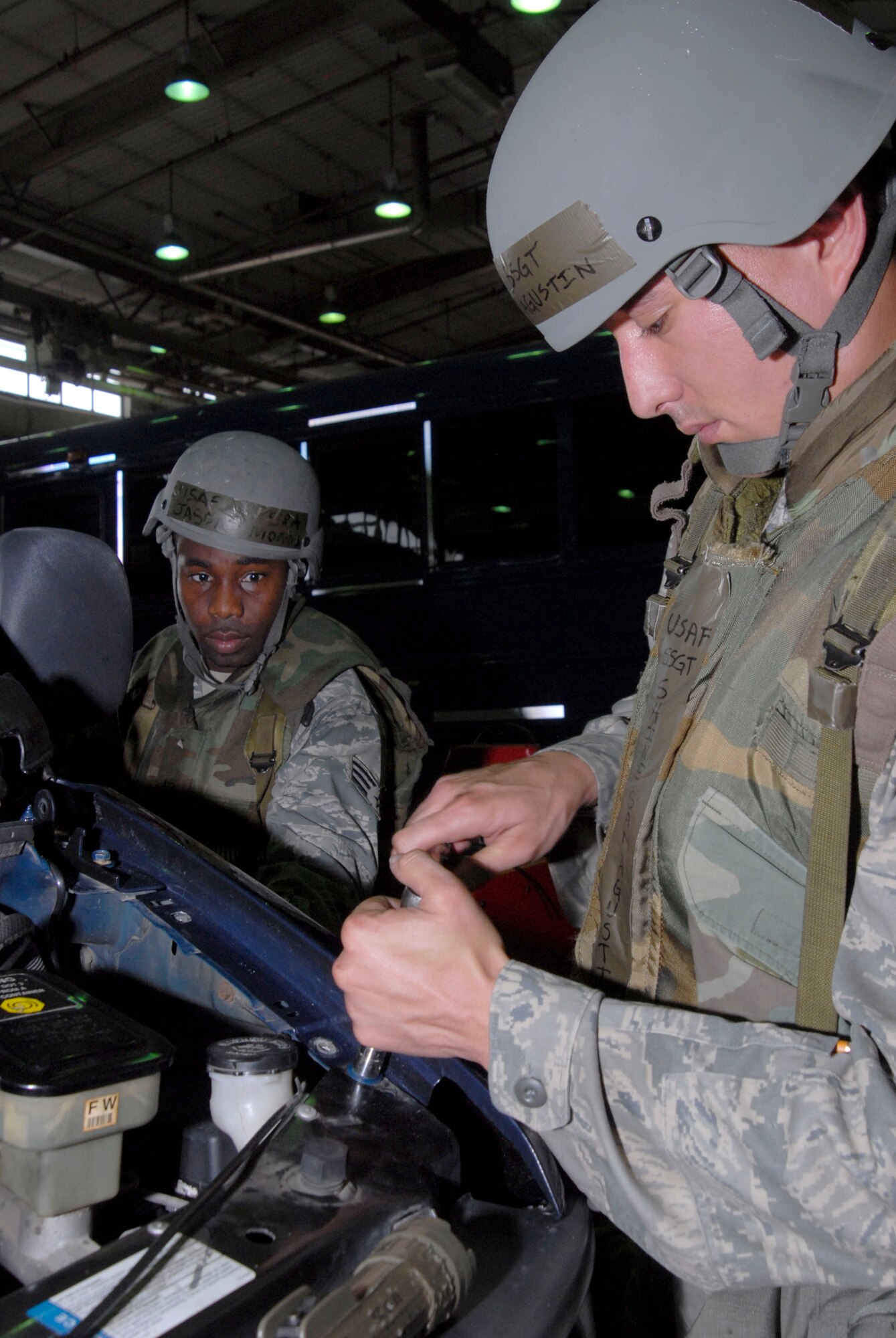 Staff Sgt. Shine San Agustin, who works vehicular equipment maintenance assigned to the 8th Logistics Readiness Squadron, uses a ratchet to put the fender of G-van on while Senior Airman Jason Morris, who works vehicular equipment maintenance assigned to the 8th Logistics Readiness Squadron, holds the fender in place July 20, at Kunsan Air Base, Republic of Korea. These Airmen are participating in a peninsula wide operational readiness exercise. Sergeant San Agustin is a native of Chalan Pago, Guam and Airman Morris is a native of Brooklyn, Ny. (U.S. Air Force photo/Staff Sgt. Darnell T. Cannady)