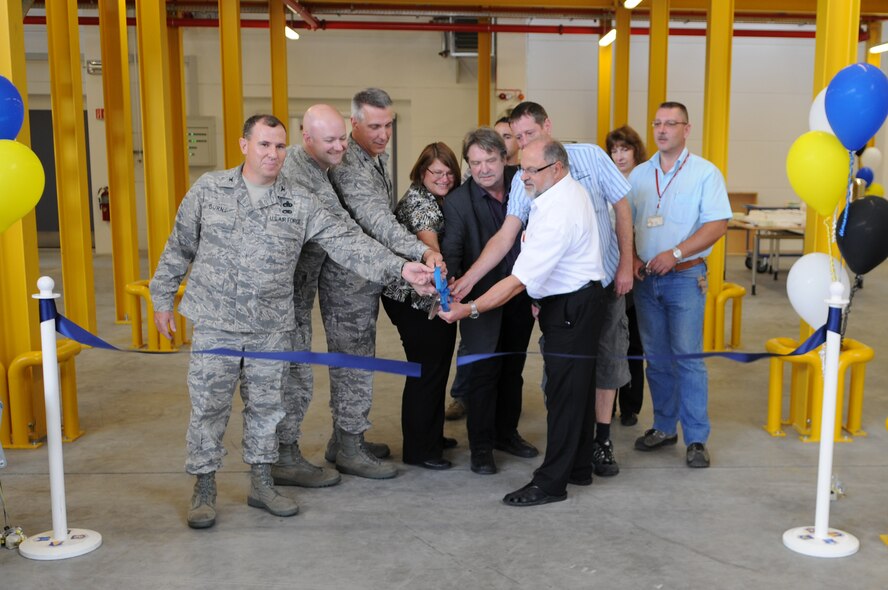 U.S. Air Force Col. Thomas Gould, 435th Air Base Wing commander, helps cut the ribbon for the new C-130J Hercules parts store, Ramstein Air Base, Germany, July 14, 2009.  The parts store is one of 14 warehouses in the Kaiserslautern Military Community. (U.S. Air Force photo by Airman 1st Class Caleb Pierce)