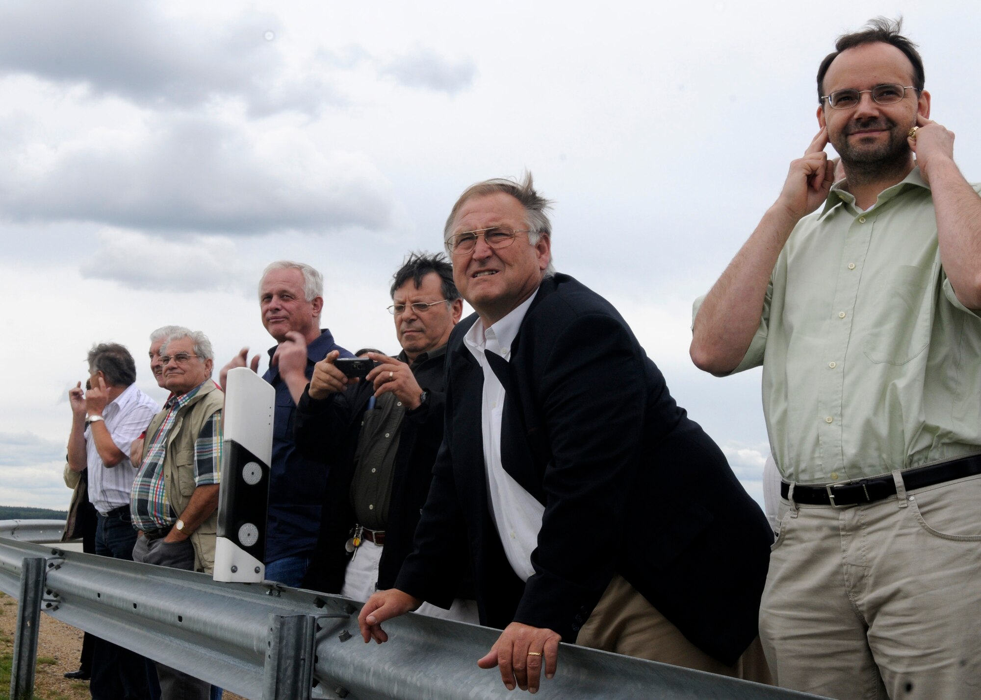 SPANGDAHLEM AIR BASE, Germany – (right to left)  Walter Faber, incoming Binsfeld mayor;  Lothar Herres, outgoing Binsfeld mayor; and Binsfeld council members look on as a C-17 Globemaster takes off July 17. The mayors and council members toured different areas around base to see recent improvements, to include better drains and a noise reducing blast fence installed to provide better community relations between Binsfeld and the 52nd Fighter Wing. (U.S. Air Force photo by Airman 1st Class Staci Miller)