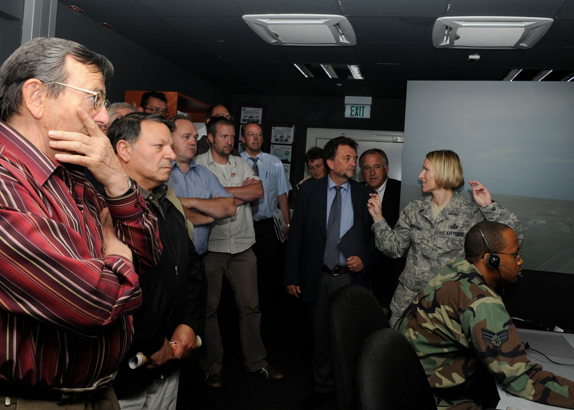 SPANGDAHLEM AIR BASE, Germany – Master Sgt. Tammy Kinder-Tims, 52nd Operations Support Squadron, describes the air traffic control training simulator to the incoming and outgoing Binsfeld Mayors and Binsfeld Council Members July 17.  The mayors and council members toured different areas around base to see recent improvements, to include better drains and a noise reducing blast fence installed to provide better community relations between Binsfeld and the 52nd Fighter Wing. (U.S. Air Force photo by Airman 1st Class Staci Miller) 