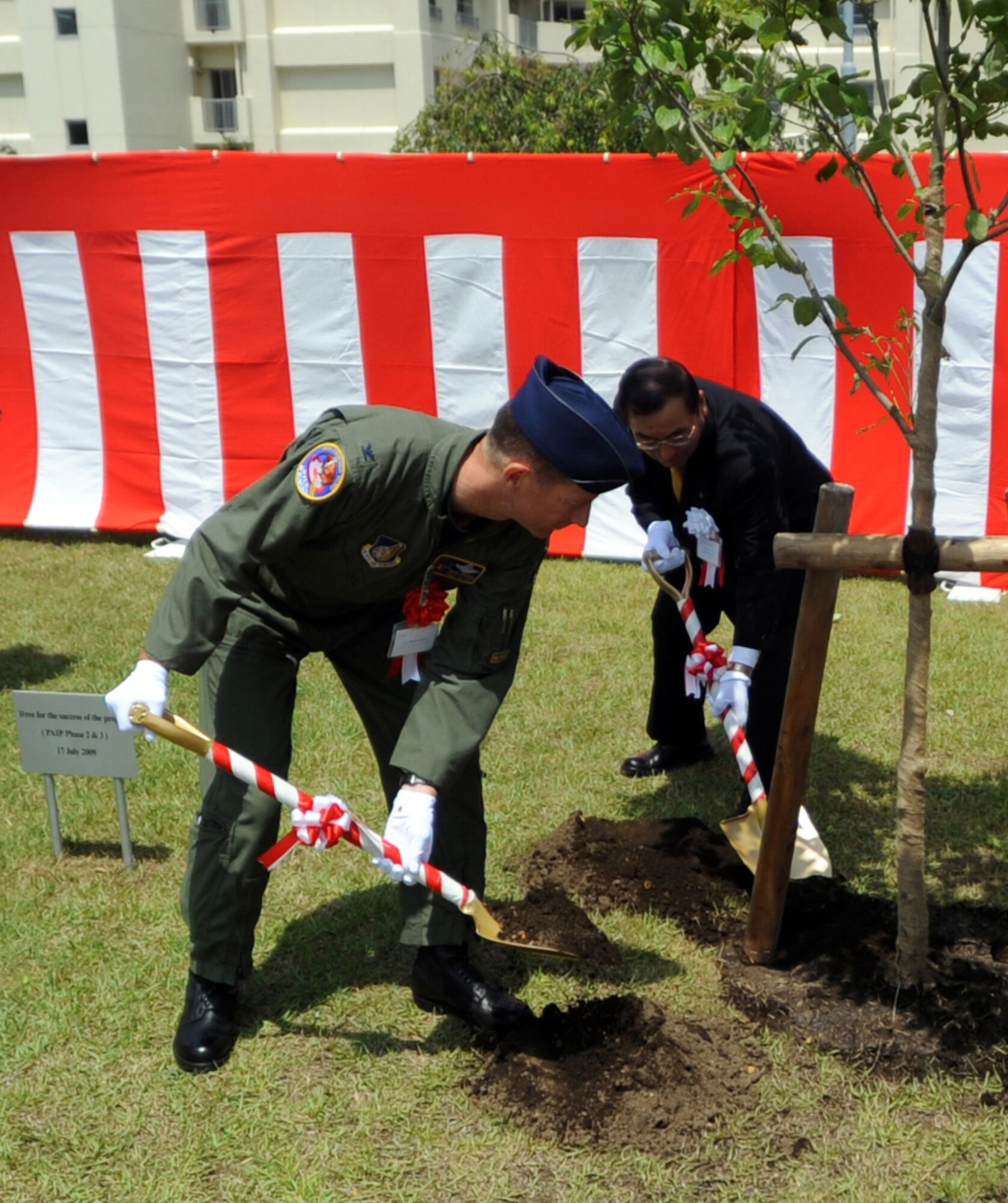 MISAWA AIR BASE, Japan -- Col. David Stilwell, 35th Fighter Wing commander, along with Tadashi Takeya, Nishimatsu Construction Corp. executive vice president, and other distinguished guests, takes part in a tree-planting ceremony to kick off the second and third phases of the Post Acquisition Improvement Program July 17 at a North Area playground. More than 500 on-base housing units will see renovations under phases two and three of the program. 