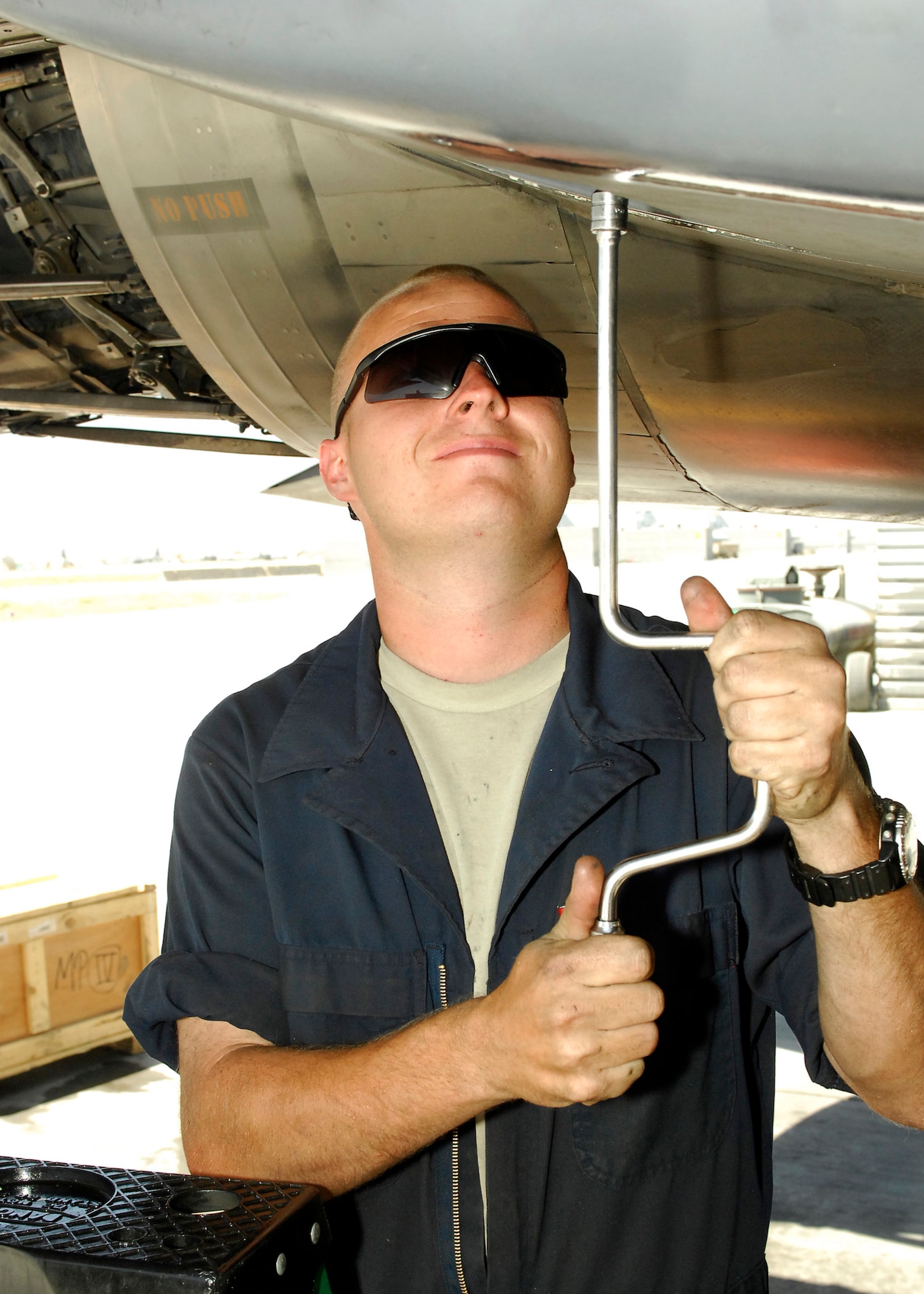 BAGRAM AIRFIELD, Afghanistan - Senior Airman Adam Greene, a crew chief from the 336th Aircraft Maintenance Squadron, removes a panel, inspects the aircraft and then replaces the panel on the F-15E, here July 20. Airman Greene is deployed from Seymour Johnson Air Force Base, N.C. and hails from Mooresboro, N.C. (U.S. Air Force photo/Senior Airman Felicia Juenke)