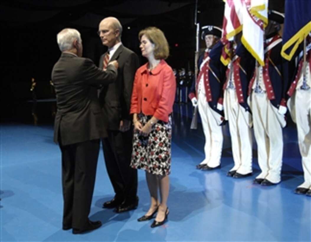 Secretary of Defense Robert M. Gates awards Secretary of the Army Pete Geren the Department of Defense Medal for Distinguished Public Service (Bronze Palm) during a farewell ceremony in his honor in Conmy Hall at Fort Myer, Va., on July 17, 2009.  