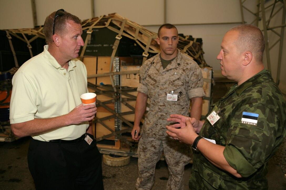 Eric Gustafson (left), Marine Forces Europe strategic mobility officer, discusses load plans and flight itineraries with an Estonian transportation officer. The Marine Forces Europe Strategic Mobility Office recently added the Estonian military during a deployment of one of their mechanized infantry battalions to Afghanistan.