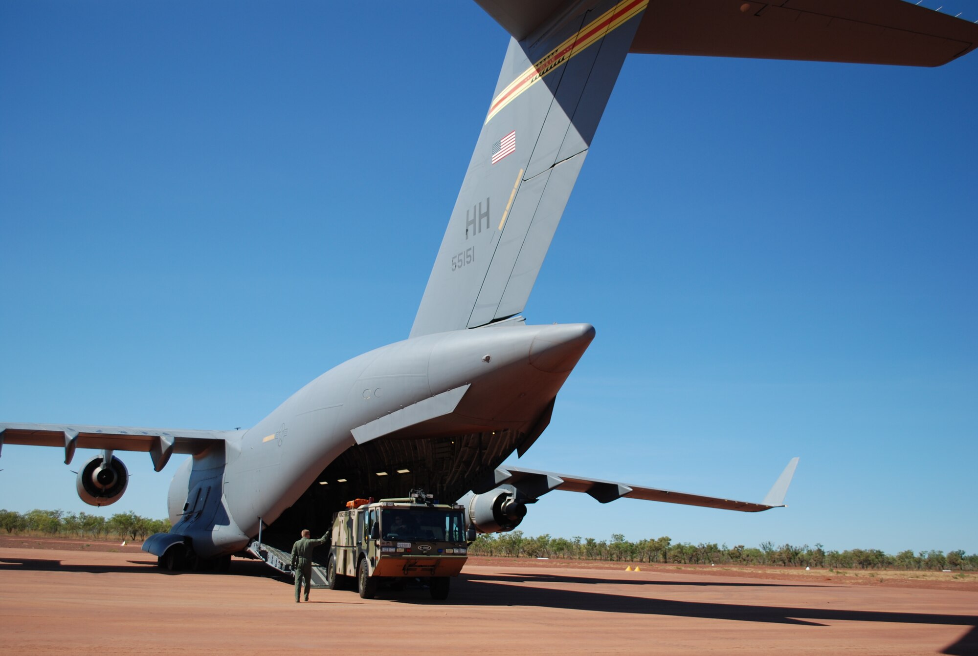 A Royal Australian Air Force E-One Titan is off-loaded at Bradshaw Field Training Area, Northern Territory, Australia, July 19 during Exercise Talisman Saber 2009. The fire truck and a six-member fire team of three U.S. and three Australian firefighters were airlifted via C-17 Globemaster III, marking the first time a fire truck of this type ever flew aboard a Globemaster III. The exercise, which ends July 25 is a biannual combined training exercise designed to strengthen interoperability between U.S. and Australian forces. (Air Force photo/ Capt. Bryan Lewis) 

