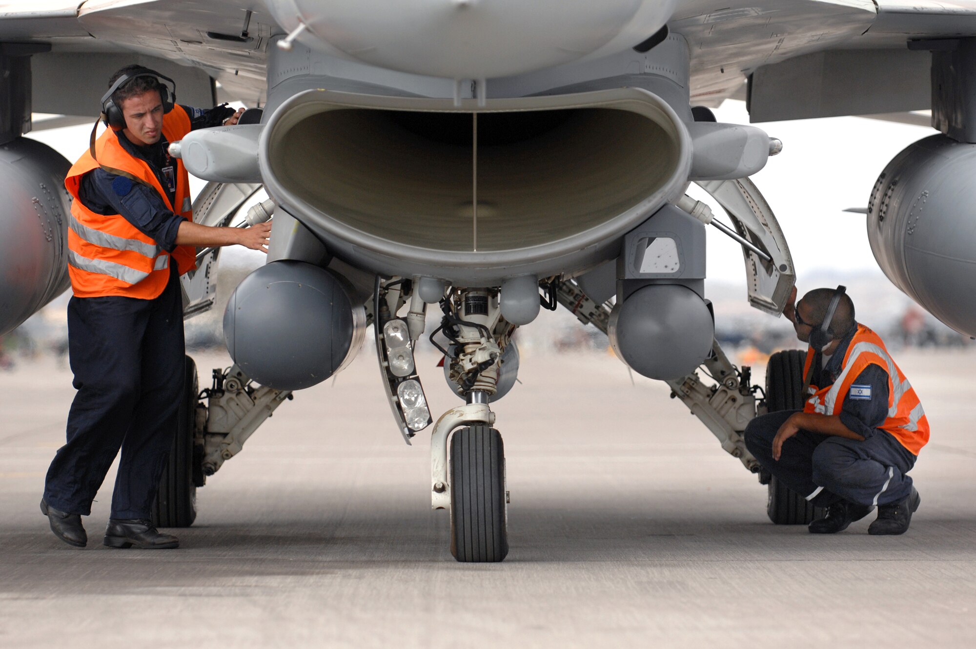 Israeli crew chiefs from Ramon Air Base, Israel perform a pre-flight check on a F-16C Falcon July 20, 2009 during Red Flag 09-4. Red Flag is a realistic combat training exercise involving the air forces of the United States and its allies. The exercise is conducted on the 15,000-square-mile Nevada Test and Training Range, north of Las Vegas. Flying for Red Flag 09-4 begins July 13 and ends July 24. U.S. aircraft will come from Nellis and Creech in Nevada, South Carolina, Idaho, the United Kingdom, Washington, Oklahoma and Ohio. Aircraft types will include F-15s, F-16s, E-3s and KC-135s. In addition to U.S. aircraft, the Israeli Air Force will be flying F-16C  Falcons. (Airman 1st Class Brett Clashman)
