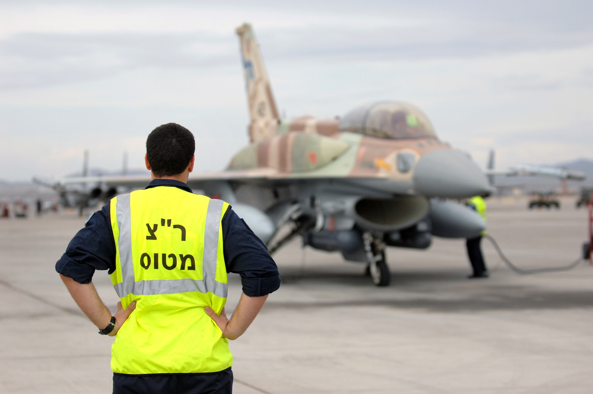 Nir, A Israeli crew chief from Ramon Air Base, Israel waits for the F-16C Falcon to taxi out July 20, 2009 during Red Flag 09-4. Red Flag is a realistic combat training exercise involving the air forces of the United States and its allies.  U.S. aircraft will come from Nellis and Creech in Nevada, South Carolina, Idaho, the United Kingdom, Washington, Oklahoma and Ohio. Aircraft types will include F-15s, F-16s, E-3s and KC-135s. In addition to U.S. aircraft, the Israeli Air Force will be flying F-16C  Falcons. (U.S. Air Force photo by Airman 1st Class Brett Clashman) 
