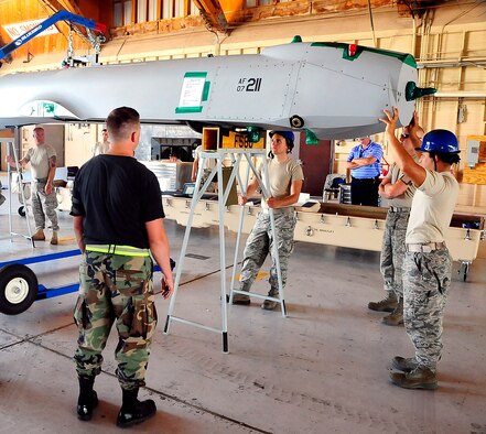 HOLLOMAN AIR FORCE BASE, N.M. -- Members of 432nd Wing place an MQ-1B Predator on a stand July 8 here. This is the first Predator ever to arrive at Holloman. (U.S. Air Force photo by Tech. Sgt. Chris Flahive)(Released)