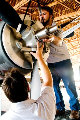 HOLLOMAN AIR FORCE BASE, N.M. -- Mr. Justin Byars alligns an MQ-9 Reaper propeller for assembly and is being assisted by Mr. Richard Kinney July 20 here. Mr. Byars and Mr. Kinney work for General Atomics Aeronautical Systems Incorporated and are assisting the Air Force with the assembly of the new fleet of unmanned aircraft. (U.S. Air Force photo by Tech. Sgt. Chris Flahive) (Released)