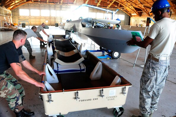 HOLLOMAN AIR FORCE BASE, N.M. -- Members of 432nd Wing remove an MQ-1B Predator from it's shipping crate July 8 here. This is the first Predator ever to arrive at Holloman. (U.S. Air Force photo by Tech. Sgt. Chris Flahive)(Released)