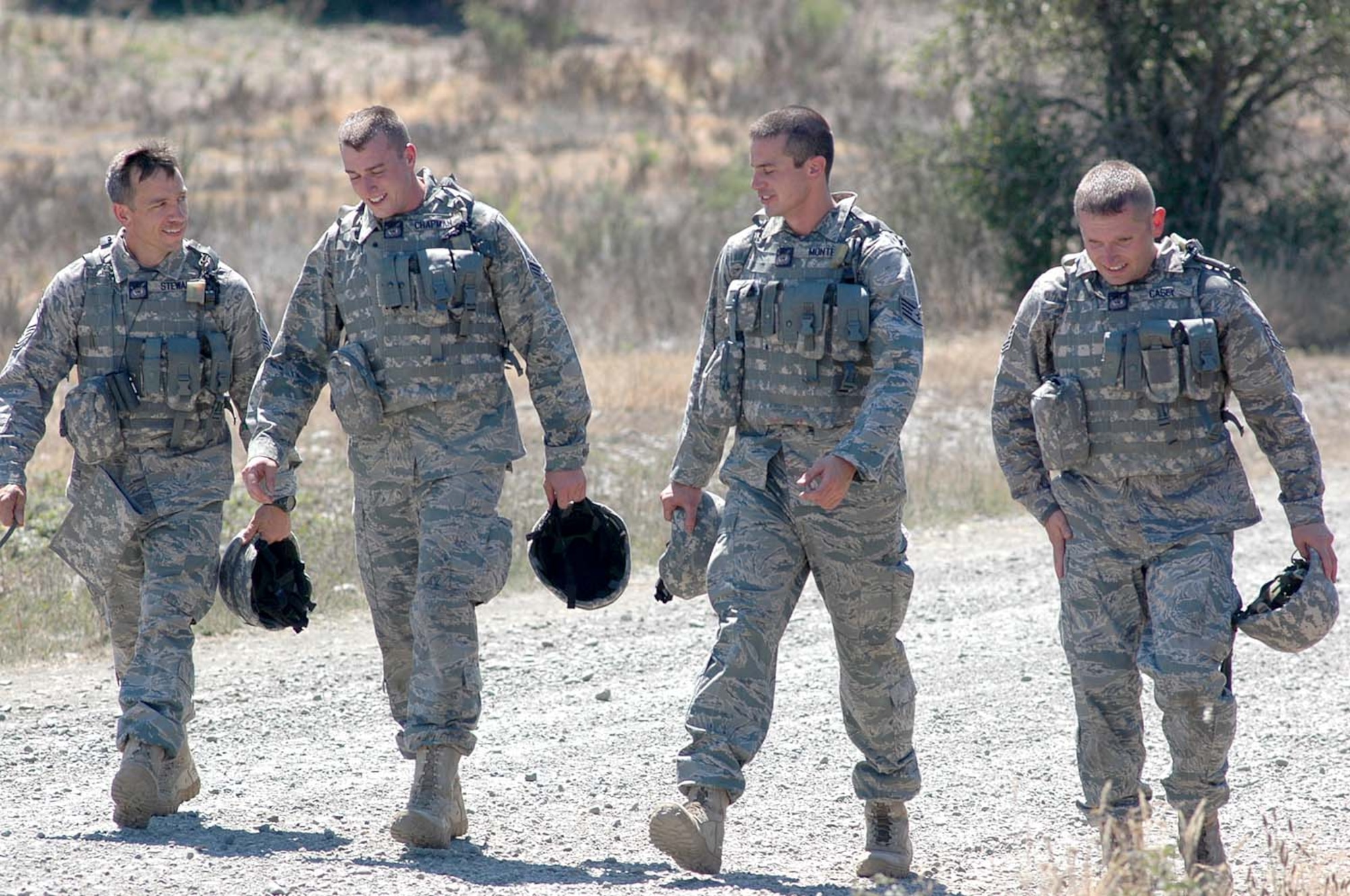 Chief Master Sgt. Ed Stewart (left to right), Senior Airman Michael Chapman, Tech. Sgt. Zachary Casey, and Staff Sgt. Jack Montez, 446th Rodeo Security Forces team, McChord Air Force Base, Wash., walk off the Combat Tactics course after completing it July 21.  Held at Fort Lewis, Wash., the Combat Tactics event is the second event the team has completed during Air Mobility Command's Rodeo 2009 at McChord, July 19-24. (U.S. Air Force photo/Tech. Sgt. Jake Chappelle)