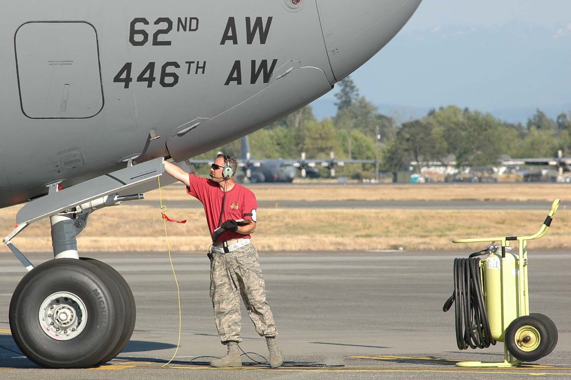 Tech. Sgt. Jerry Kallinen, a team member with the 446th Airlift Wing Rodeo Maintenance team, McChord Air Force Base, Wash., checks a panel on a C-17 GLobemaster III during the ground refueling event at Rodeo 2009 at McChord. The team anticipates a score of 80 out of a possible 100 points. Air Mobility Command's Rodeo 2009 is July 19-24. (U.S. Air Force photo/Tech. Sgt. Jake Chappelle)
