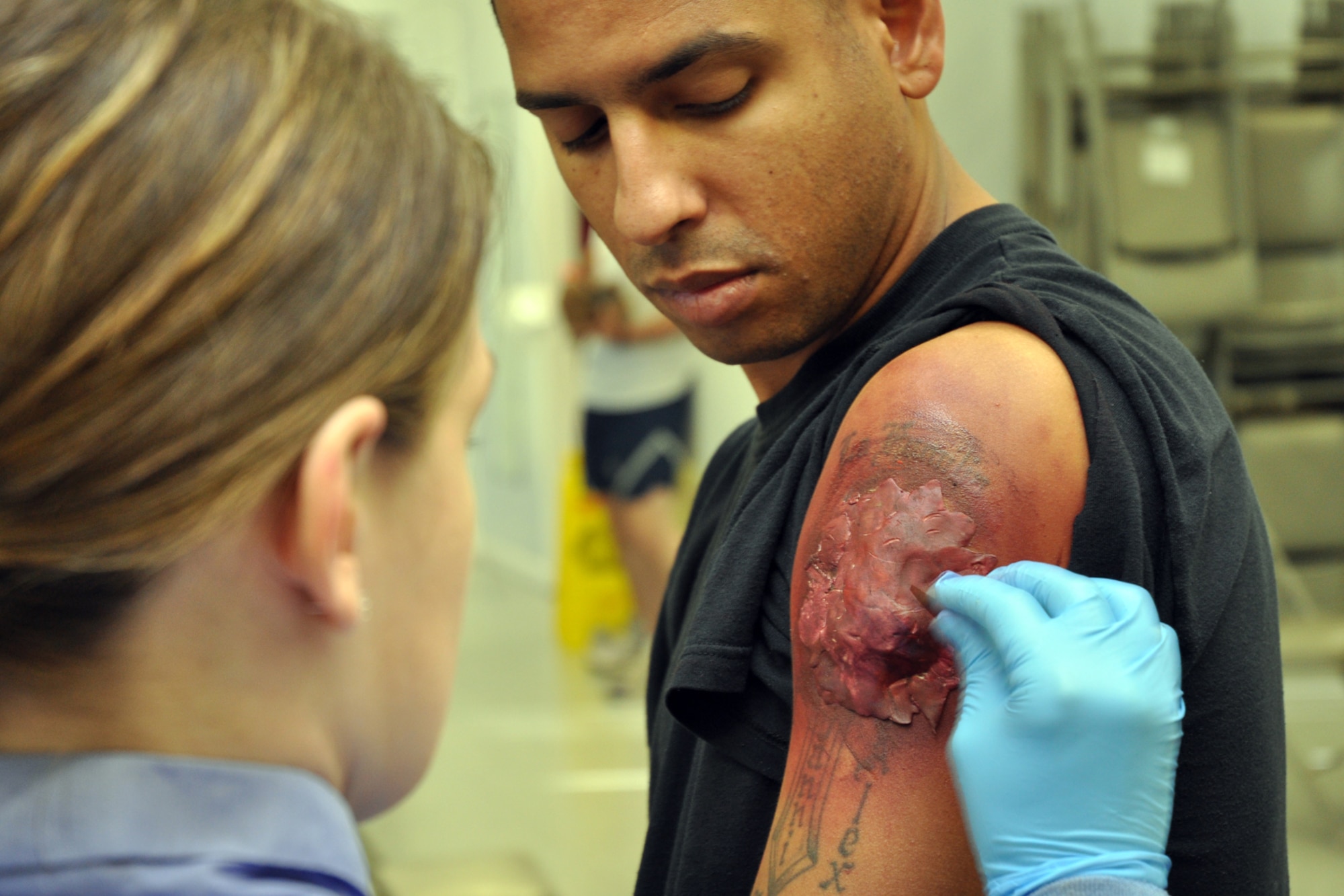 EGLIN AIR FORCE BASE, Fla. – Airman 1st Class Elizabeth Ortiz, 96th Medical Support Squadron moulage team, applies moulage to a patient at the West Gate Chapel for an exercise July 22. Moulaging victims for exercise scenarios enable medical personnel to better train for real-world possible situations when they deploy. (U.S. Air Force photo/ Airman Anthony Jennings)