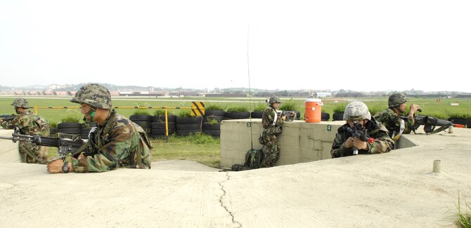 Republic of Korea army forces and 51st Security Forces Squadron Airmen keep a look out on the flight line during exercise Beverly Bulldog 09-03 at Osan Air Base, Republic of Korea, July 22. (U.S. Air Force photo/Senior Airman Stephenie Wade)