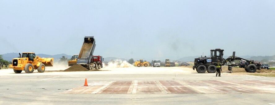 The Airfield Damage Repair team from the 51st Civil Engineer Squadron make and fill craters on the simulated flightline during exercise Beverly Bulldog 09-03 at Osan Air Base, Republic of Korea, July 22. (U.S. Air Force photo/Senior Airman Stephenie Wade)