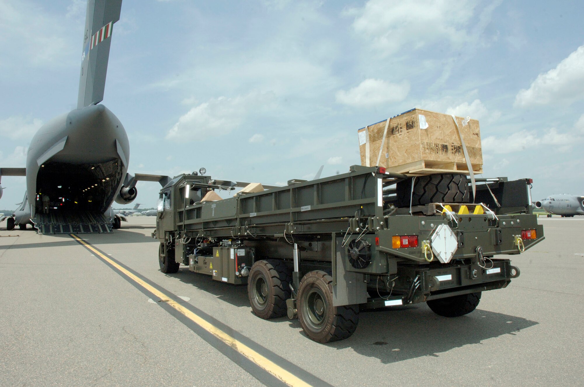 A next generation small loader straight from the assembly line is loaded onto a C-17 bound for Papa AB, Hungary July 17. Papa AB is an old Soviet air force fighter base that is currently being used as a NATO base. (U.S. Air Force photo/Staff Sgt. Marie Cassetty)(RELEASED)