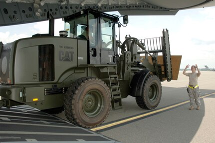 Senior Airman Ashley Kelly marshals a 10K all-terrain forklift onto the back of a C-17 bound for Papa AB, Hungary July 17. The Heavy Airlift Wing at Papa AB is a multi-national wing with all 12 nations of NATO having at least one person participating. Airman Kelly is a load team chief assigned to the 437th Aerial Port Squadron. (U.S. Air Force photo/Staff Sgt. Marie Cassetty)(RELEASED)