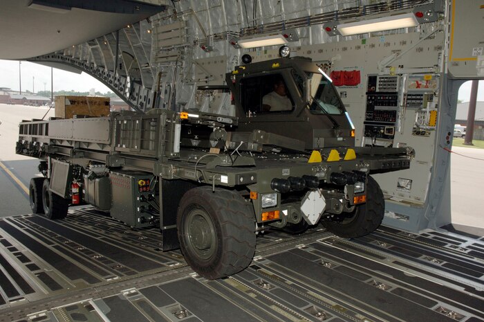 Airmen with the 437th Aerial Port Squadron load a next generation small loader onto the back of a C-17 bound for Papa AB, Hungary July 17. Brand new equipment consisting of two NGSLs, a Lavatory Service Truck and a 10K all-terrain forklift, were loaded onto the aircraft and will be used as support equipment for all of the ground operations for the C-17. (U.S. Air Force photo/Staff Sgt. Marie Cassetty)(RELEASED)