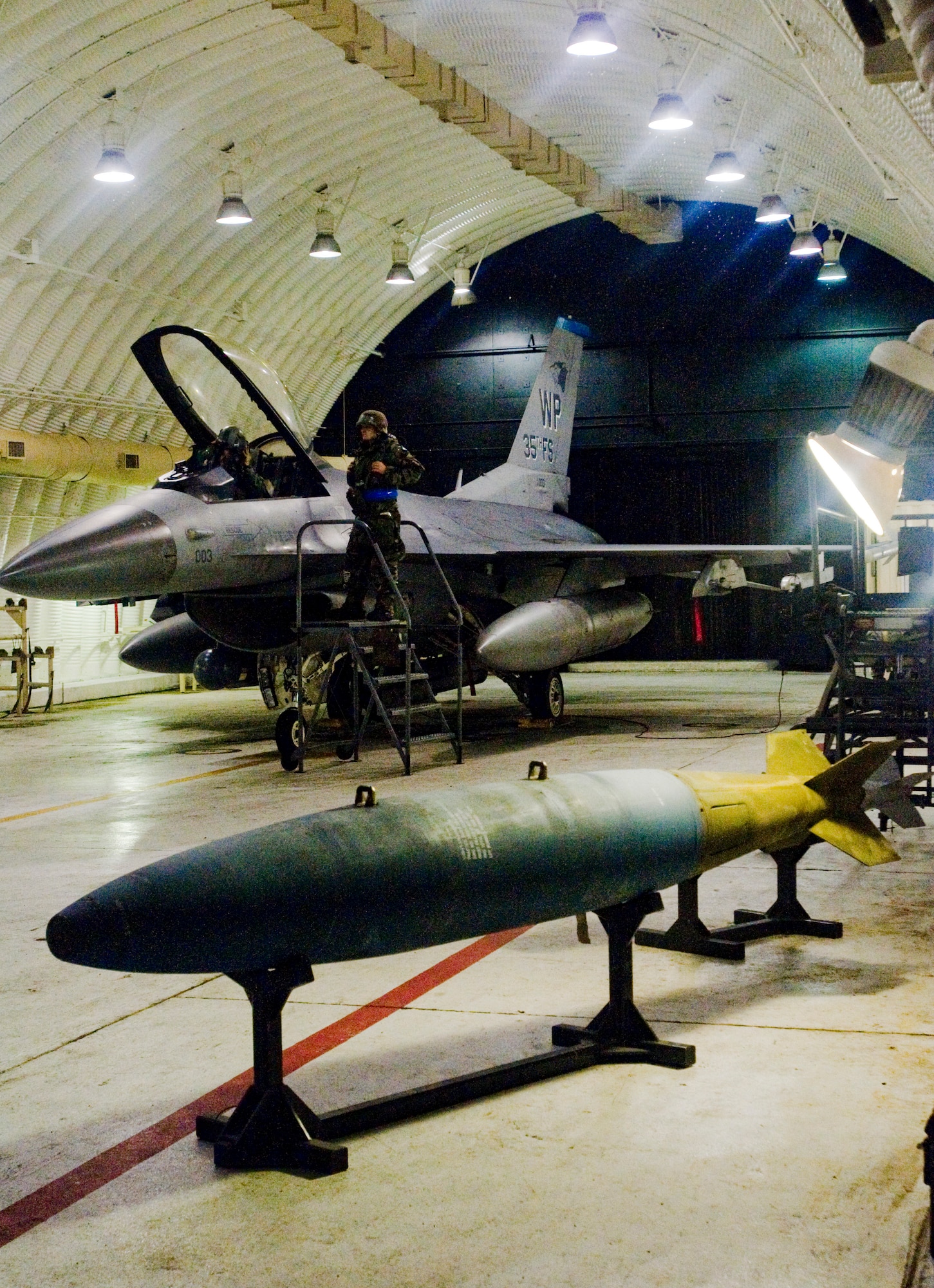 KUNSAN AIR BASE, Republic of Korea -- Senior Airman Michael Scott, 35th Aircraft Maintenance Unit, aids Lt. Col. Mark Welhaf, 8th Fighter Wing, with starting up an F-16 during an operational readiness exercise here July 22. Airman Scott and the rest of the 8th Fighter Wing continue the mission, even after switching between mission-oriented protective postures, during the exercise. (U.S. Air Force photo/Senior Airman Jonathan Steffen) 