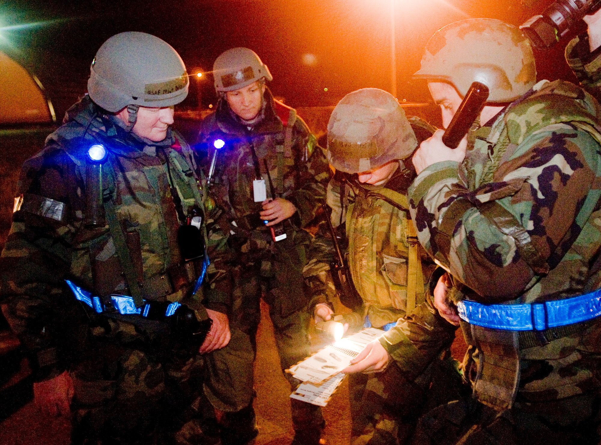Senior Airman Tony Park and Airman First Class Nathan Brown, 8th Aircraft Maintenance Squadron, 35th Aircraft Maintenance Unit, look through an Airman’s Manual to help identify an unexploded ordnance while Master Sgt. Billy Landwher and Tech Sgt. Eric Mayes, 8th Maintenance Operations Squadron, evaluate the two Airmen on post attack reconnaissance procedures July 22. The PAR team also looked for damage to assets and casualties. (U.S. Air Force photo/Senior Airman Jonathan Steffen)