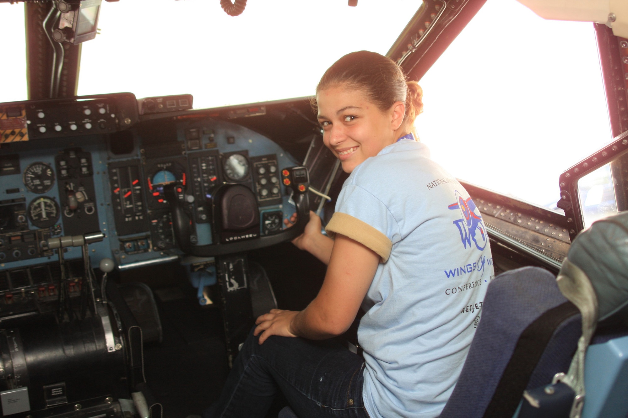 WRIGHT-PATTERSON AIR FORCE BASE, Ohio - Angel Buzard enjoys the view from the flight deck of a C-5 Galaxy aircraft.  Ms. Buzard and 45 other young women in grades 9-12 attended the Third Annual Wings of Women Conference July 17.  Part of the day-long event included a stop at the 445th Airlift Wing for a wing mission briefing, 445th Aeromedical Evacuation Squadron presentation and C-5 tour.  (Air Force photo/Senior Airman Mikhail Berlin)