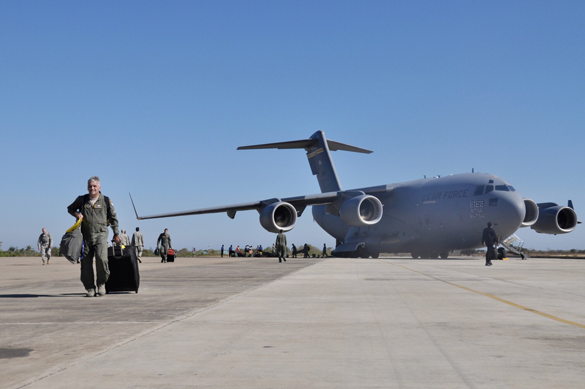 Airmen from various bases across the total force community unload their equipment and supplies from a C-17 Globemaster III after landing July 15 to support Operation Pacific Angel 2009 in Kupang, Indonesia. An aircrew from the Hawaii Air National Guard's 204th Airlift Squadron at Hickam Air Force Base, Hawaii, delivered the people and equipment for the operation. (U.S. Air Force photo/Tech. Sgt. Cohen A. Young) 