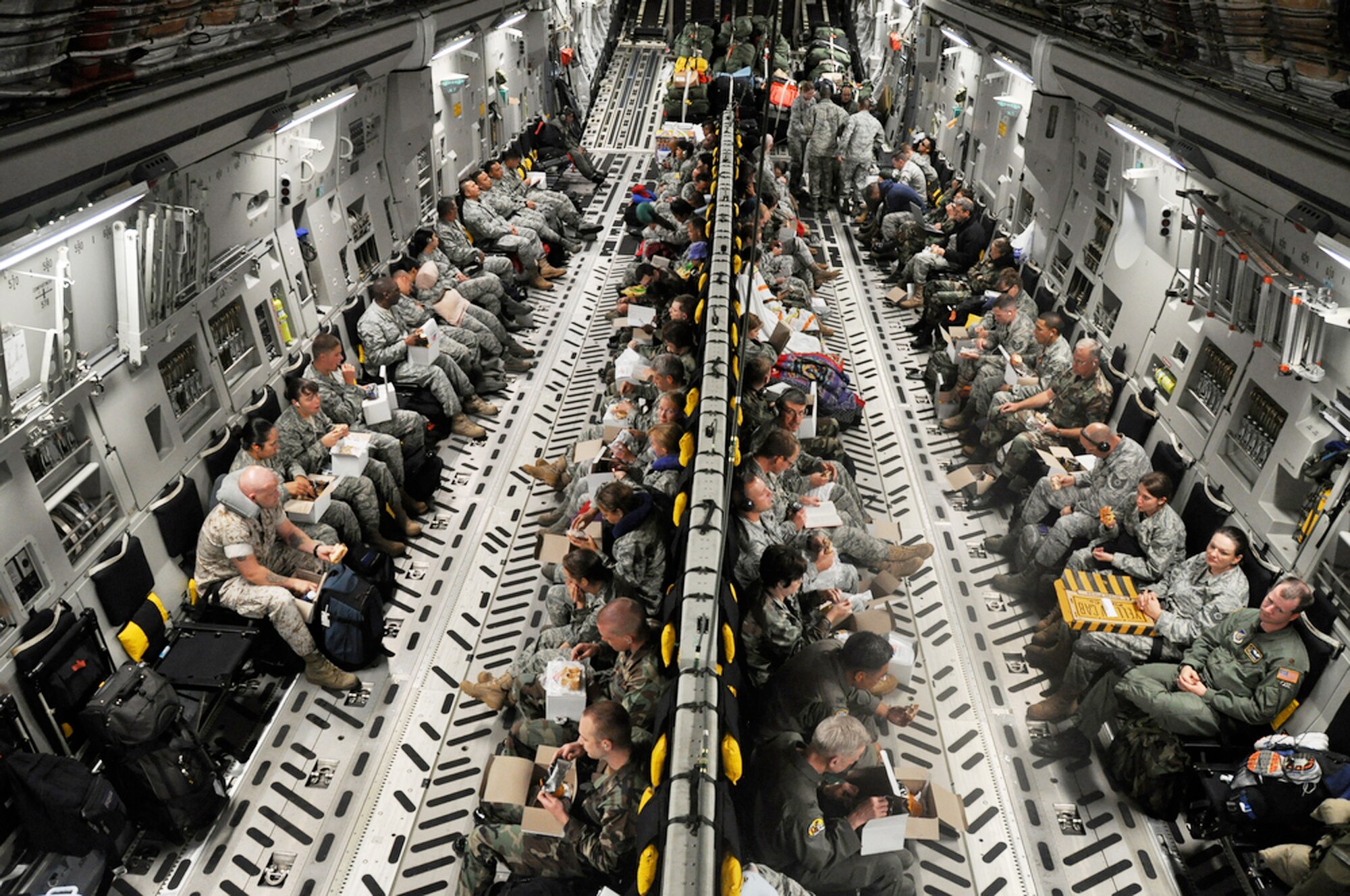 Medical and engineering Airmen from various bases across the Air Force get some rest aboard a C-17 Globemaster III July 15 en route to Kupang, Indonesia. An aircrew from the Hawaii Air National Guard's 204th Airlift Squadron at Hickam Air Force Base, Hawaii, delivered the people and equipment for the operation. (U.S. Air Force photo/Tech. Sgt. Cohen A. Young)