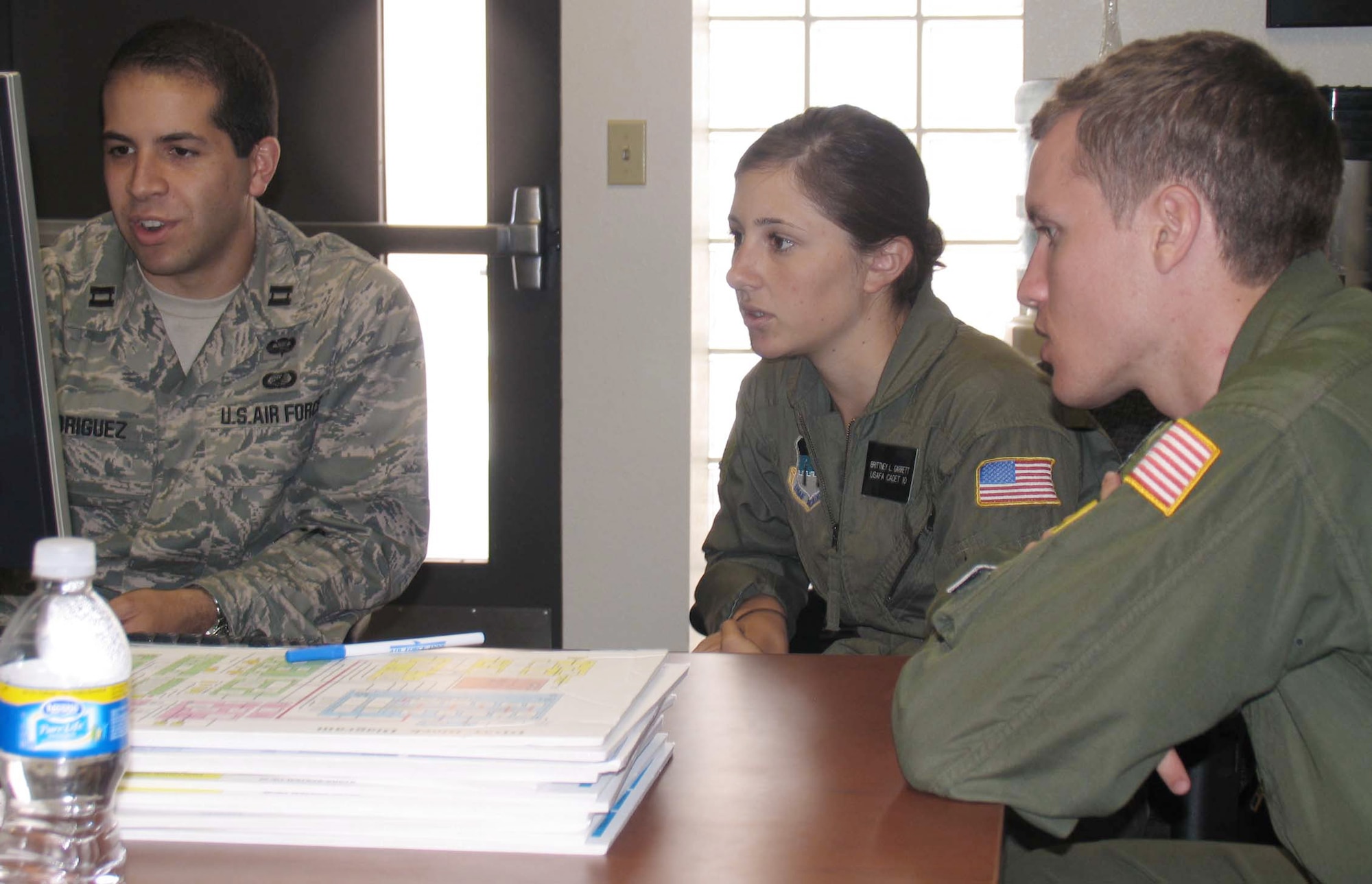 Capt. James Rodriguez works with Cadets First Class Brittney Garrett and Mark Price as they analyze questionnaire and reliability data for the Department of Defense National Airspace System during the U.S. Air Force Academy's Cadet Summer Research Program. During the five-week program, cadets gained hands-on exposure to operational testing processes, products and experiences. Captain Rodriguez is from the Air Force Operational Test and Evaluation Center's Detachment 3 at Kirtland Air Force Base, N.M. (U.S. Air Force photo)