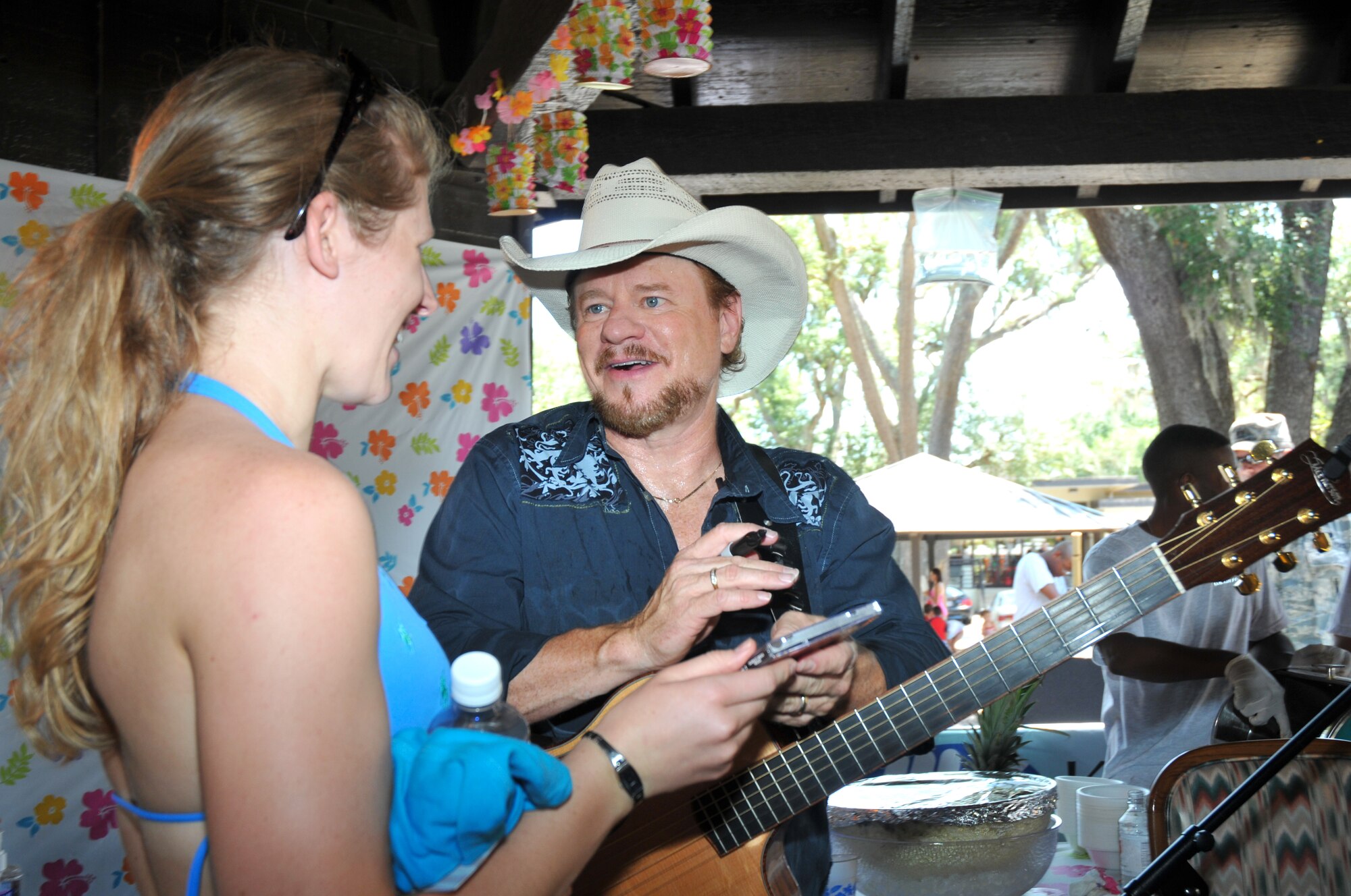 Betsy Forster, left, has country music star Paul Overstreet autograph a CD.  Mrs. Forster’s husband is Staff Sgt. Mat Forster, 85th Engineering Installation Squadron.  Sergeant Forster currently on temporary duty in England.   (U.S. Air Force photo by Adam Bond)