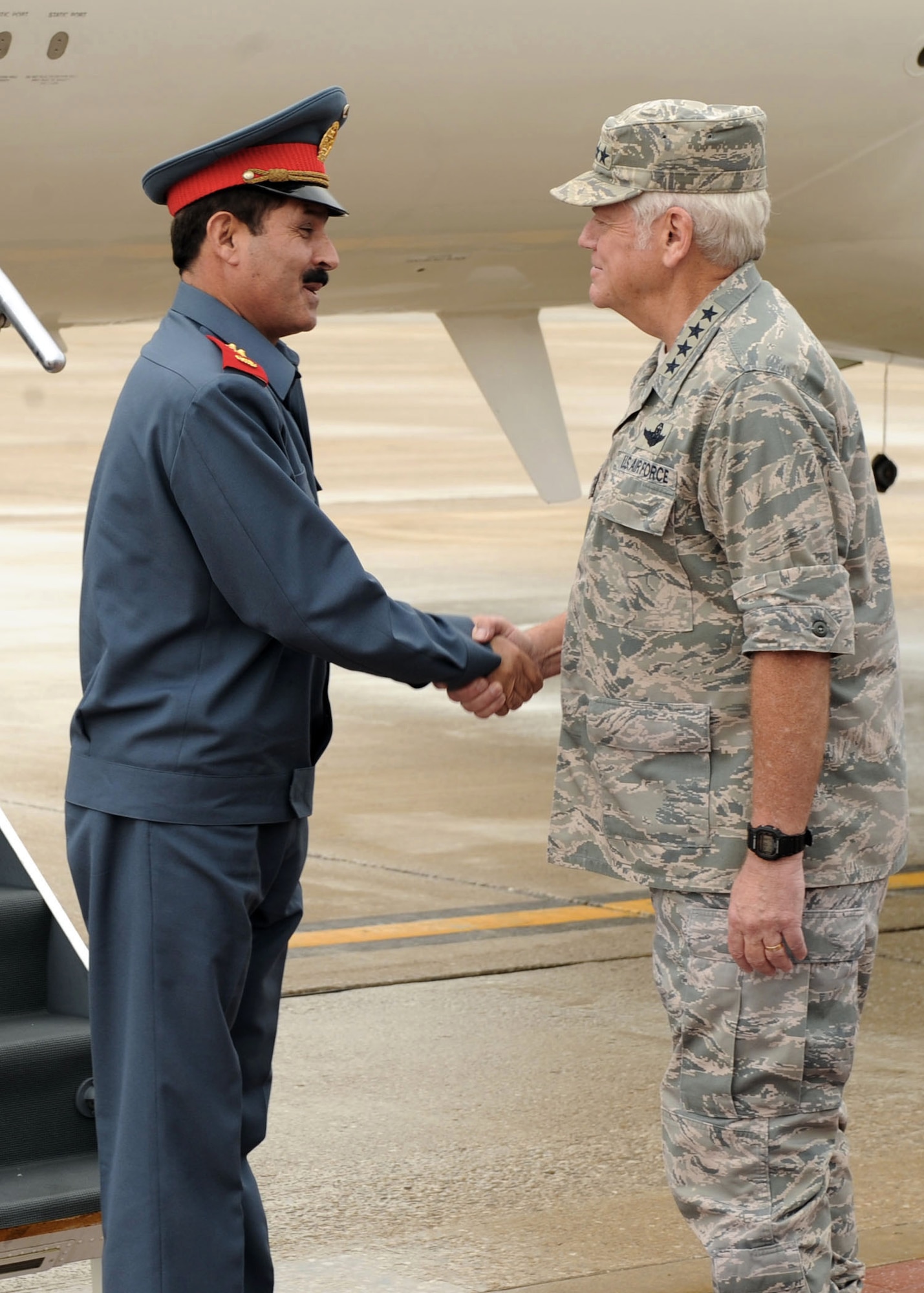 Gen. Arthur J. Lichte, commander of Air Mobility Command, greets Maj. Gen. Mohammad Dawran, commander of the Afghan National Army Air Corps, as he arrives at Scott Air Force Base, Ill., July 15.  General Dawran's visit here was to continue an open dialog between senior military leaders of the two countries and to reinforce airlift concepts that are being applied throughout Afghanistan. (U.S. Air Force photo/Airman 1st Class Wesley Farnsworth) 
