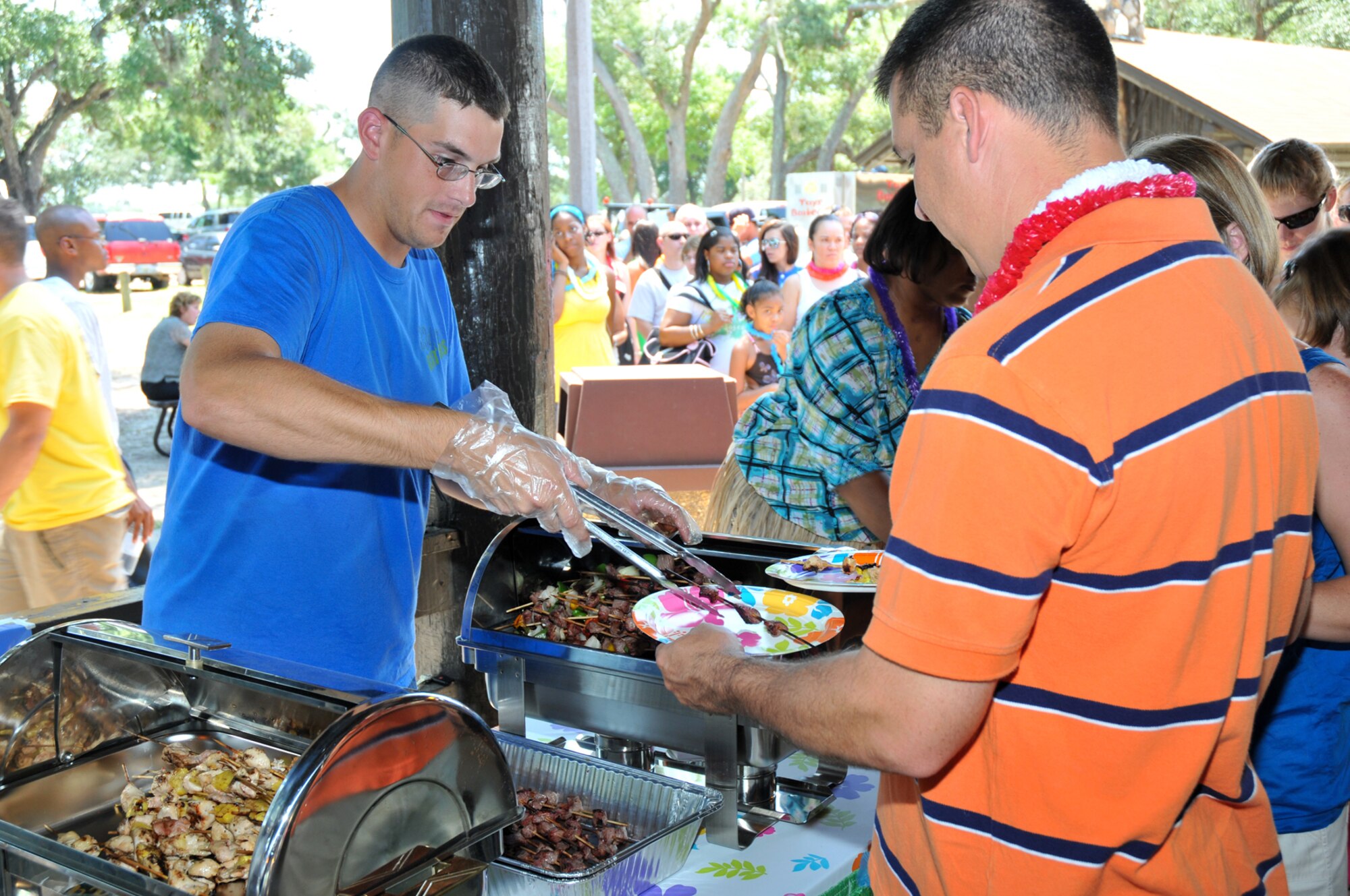Right, Airman 1st Class James Dibattista, 334th Training Squadron, serves a kabob to Tech. Sgt. Anthony Wallis, 81st Logistics Readiness Squadron.   (U.S. Air Force photo by Adam Bond)