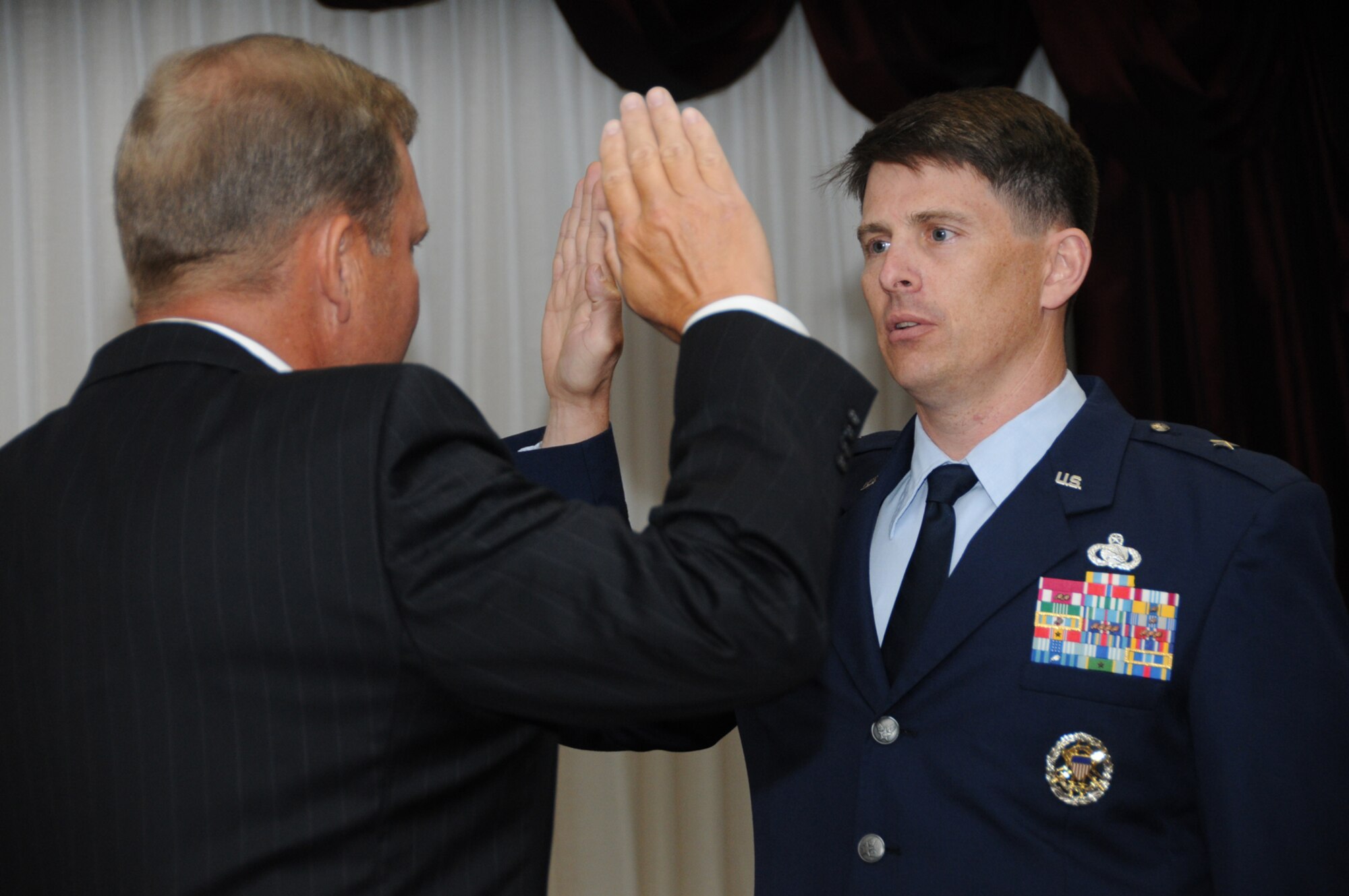 Retired Lt. Gen. Michael Peterson, left, administers the oath of office to Brig. Gen. Ian Dickinson, 81st Training Wing commander, as he assumes his new rank Monday.  General Peterson, who retired Feb. 1, was the wing’s commander from May 2002 to April 2004.  (U.S. Air Force photo by Kemberly Groue)