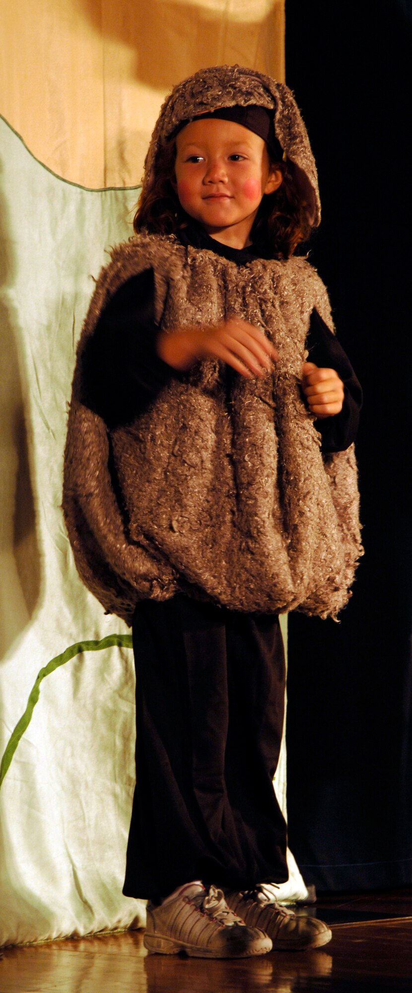 MCCONNELL AIR FORCE BASE, Kan. -- Skylar Baxley, daughter of Master Sgt. James Baxley, 22nd Security Forces Squadron, and Master Sgt. Tarah Baxley, 22nd Medical Support Squadron, performs in the Missoula Children’s Theatre play, “The Princess and the Pea,” as a dust bunny from the land of riverdom at the base theater, July 18. Skylar performed two songs alongside nineteen other dust bunnies embracing the importance of saying “peas” and “thank you.” (Photo by Senior Airman Laura Suttles)