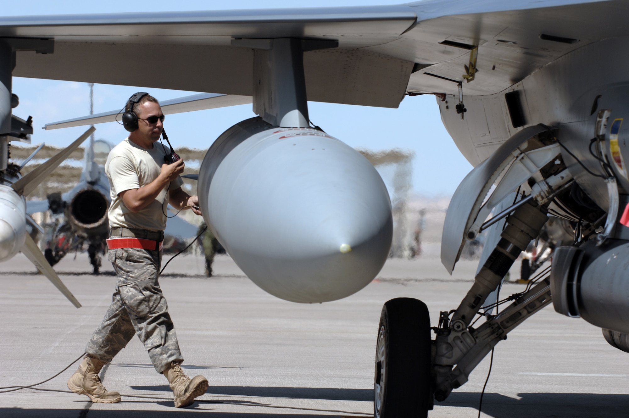 Staff Sgt. William Reeder goes over pre-flight checks before launching a F-16CJ Wild Weasel at Red Flag 09-4 July 16 at Nellis Air Force Base, Nev. Red Flag is a highly realistic combat training exercise that pits U.S. and allied nation air forces against "enemy" forces in a challenging threat environment. Sergeant Reeder is a crew chief with the 77th Fighter Squadron. (U.S. Air Force photo/Tech. Sgt. Michael R. Holzworth)
