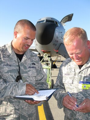 MCCHORD AFB, Wash. -- Tech. Sgt. Billy Martin and Master Sgt. Al Ryder, 931st Aircraft Maintenance Squadron, review technical orders for properly removing an accumulator.  Sergeant Ryder is the team chief for Team McConnell’s RODEO maintenance team.  The RODEO maintenance competition consists of three separate maintenance ground events: preflight inspection, aircraft refueling and basic post flight. (Photo by Tech. Sgt. Chyrece Campbell) 