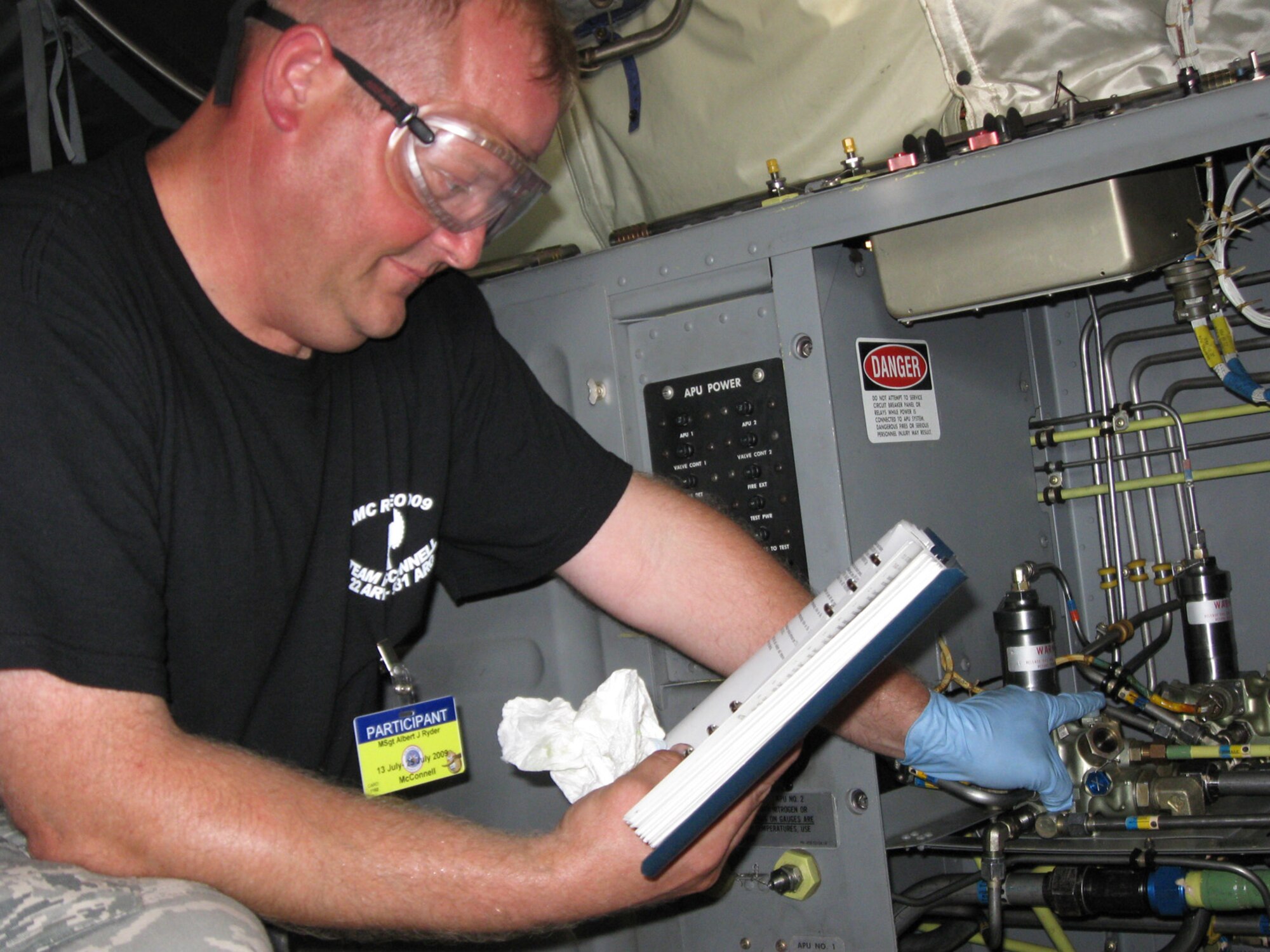 MCCHORD AFB, Wash. -- Master Sgt. Al Ryder, 931st Aircraft Maintenance Squadron, reviews technical orders during a check of a possible accumulator leak on a KC-135 Stratotanker.  (Photo by Tech. Sgt. Chyrece Campbell)