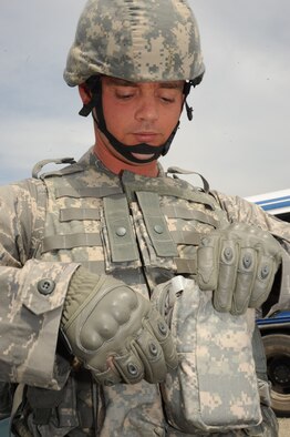 MCCHORD AFB, Wash. -- Senior Airman Nathan Shelley, 931st Military Support Flight, performs a check of his equipment to ensure he has all the proper gear needed for the RODEO tactics competition.  Team McConnell’s security forces members’ will compete in three of the four different security forces RODEO events: combat tactics, combat endurance and weapons. (Photo by Tech. Sgt. Chyrece Campbell)  