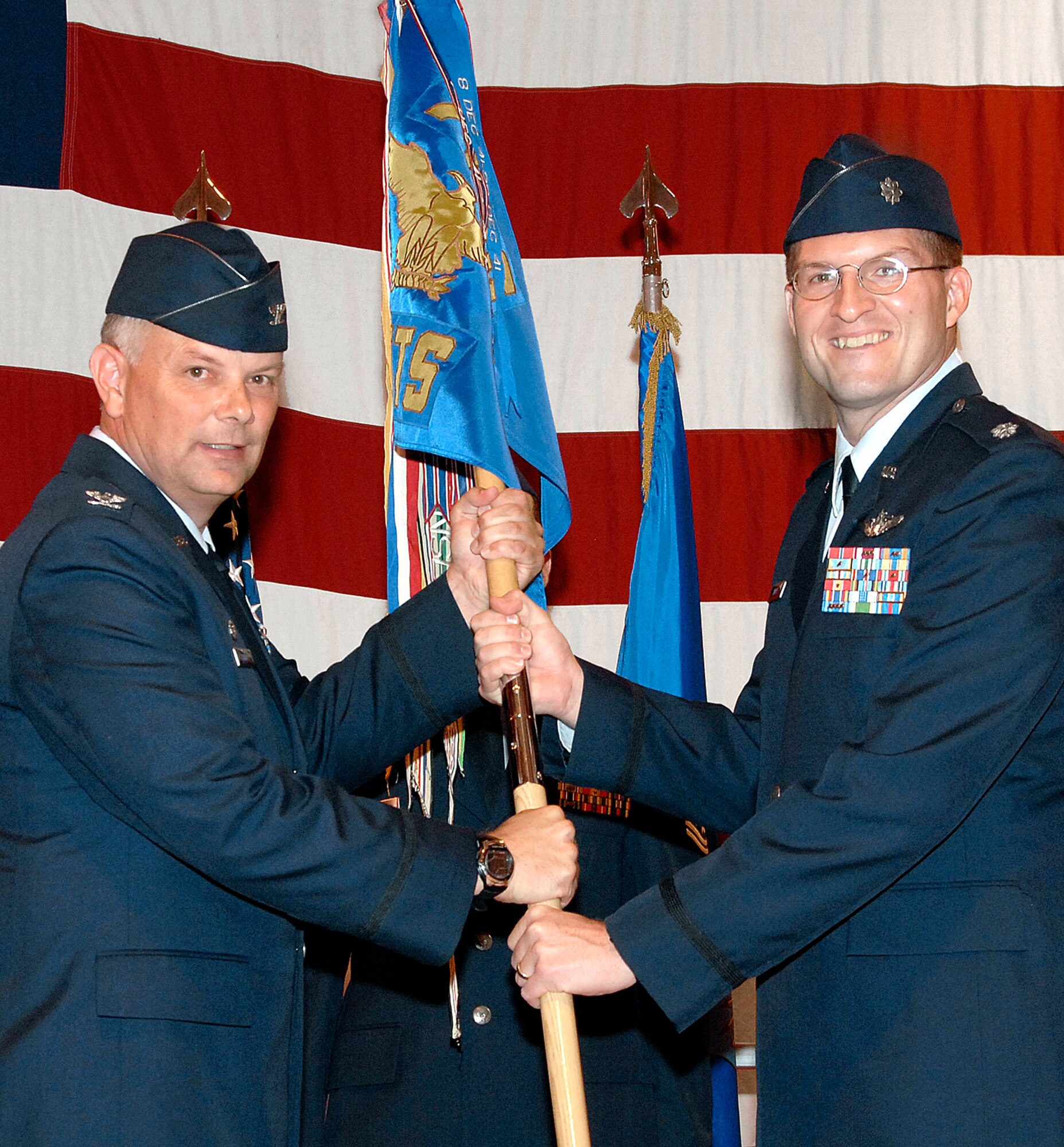 Lt. Col. Clint Hinote, right, accepts command of the 3rd Fighter Training Squadron from Col. Glen VanHerck, 71st Operations Group commander, during an assumption of command ceremony held July 21 in Hangar 170 at Vance AFB. Colonel Hinote comes to Vance after serving as aide to Gen. Stephen R. Lorenz, commander of the Air Education and Training Command at Randolph AFB, Texas. (U.S. Air Force photo/ Terry Wasson)