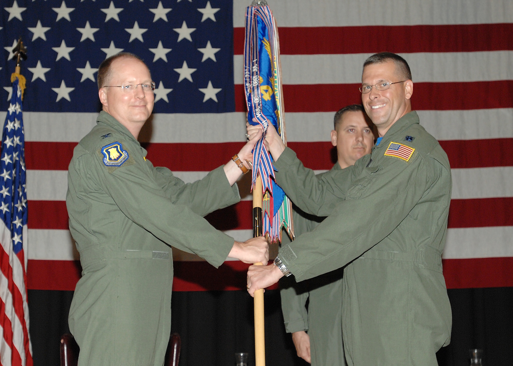 MCCONNELL AIR FORCE BASE, Kan. -- Col. Billy Langford, 22nd Operations Group commander, passes the 384th Air Refueling Squadron guidon to Lt. Col. Samuel Chesnut, giving him command of the squadron during a change of command ceremony, July 17. (Photo by Staff Sgt. Jamie Train)